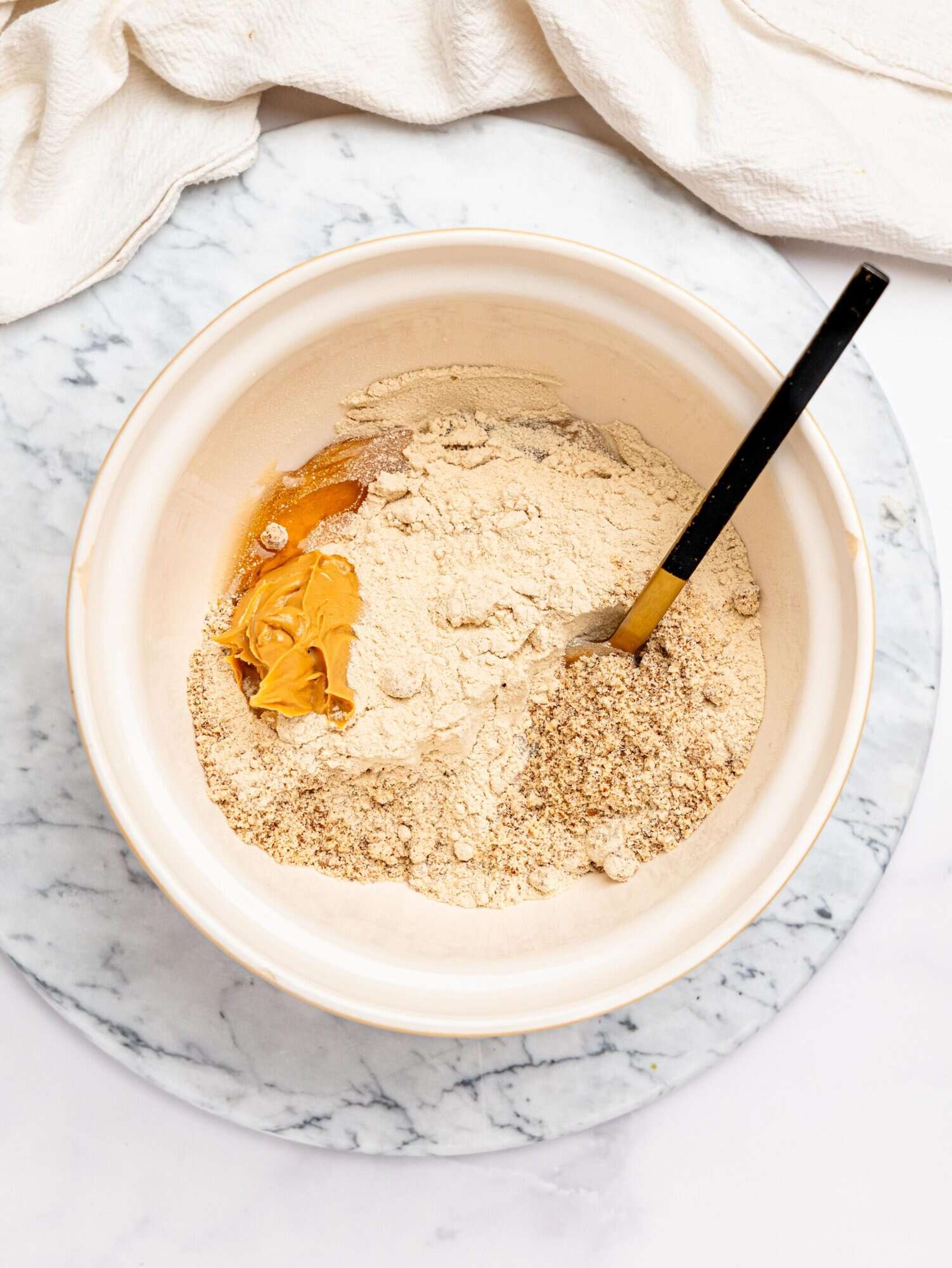 Healthy snickers base ingredients in a mixing bowl.