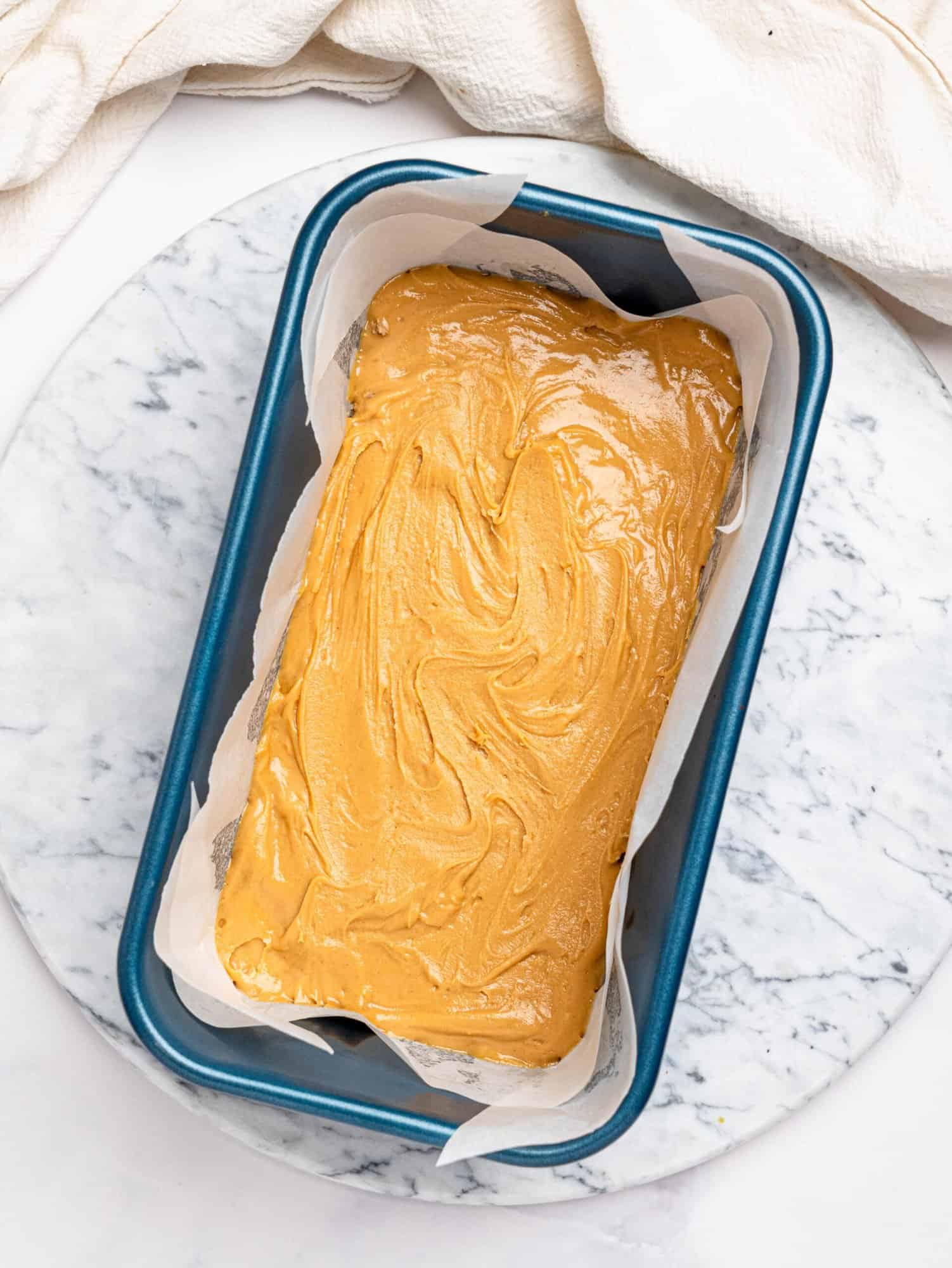 Protein snickers base and filling in a loaf pan.