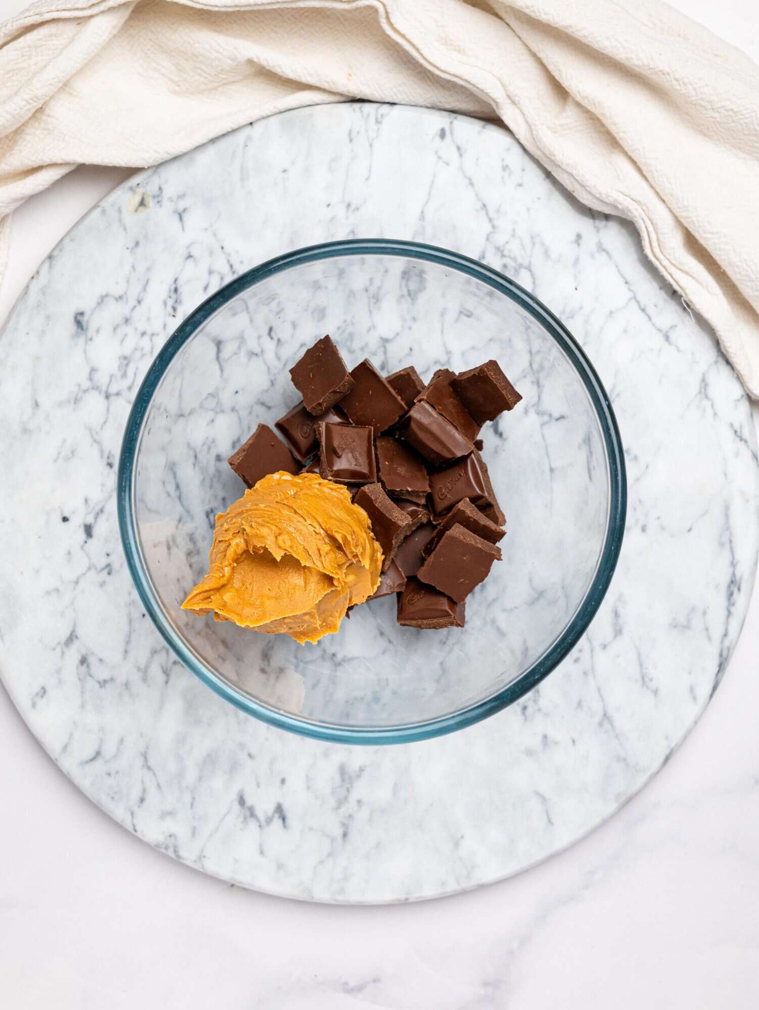 Dark chocolate and peanut butter in a glass bowl.