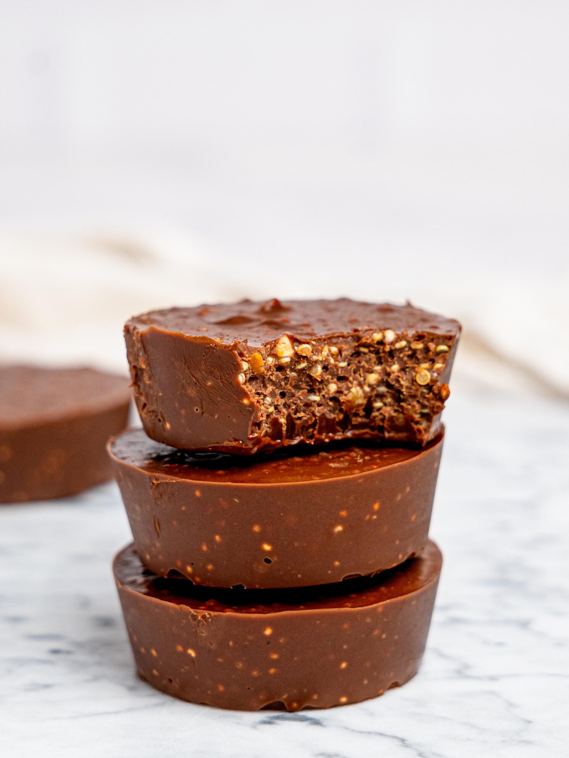 Three quinoa crunch cups stacked on top of each other.