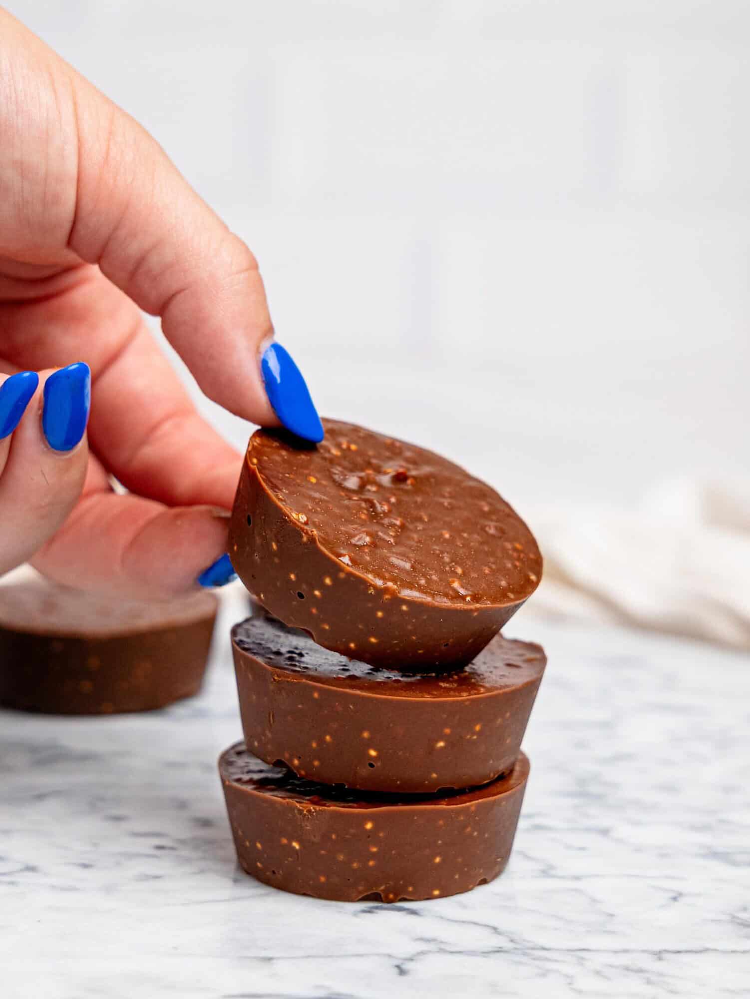 Three quinoa crunch cups stacked on top of each other.