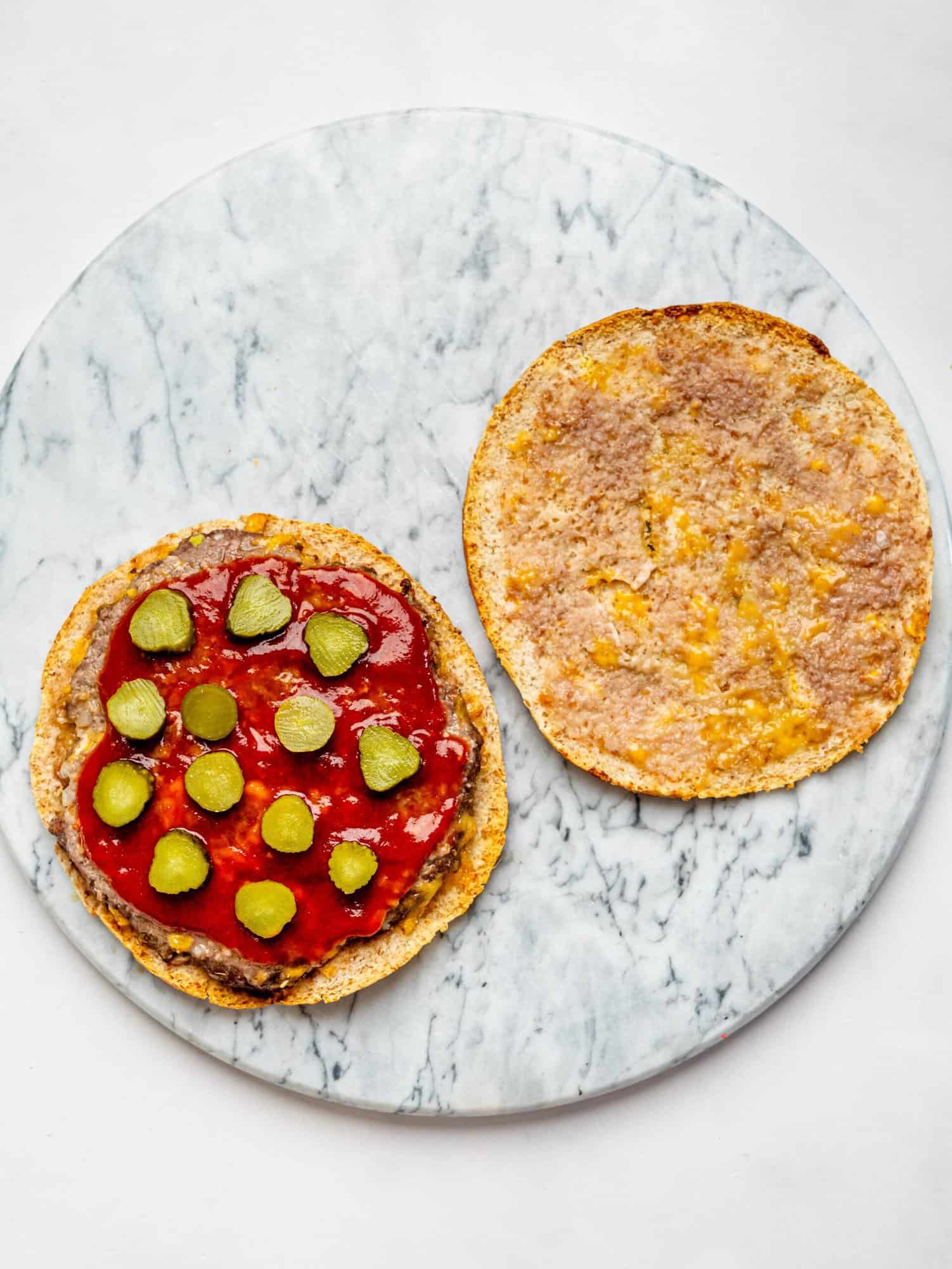 Crispy Pita Burger after being in the air fryer - opened then topped with ketchup and sliced pickles.