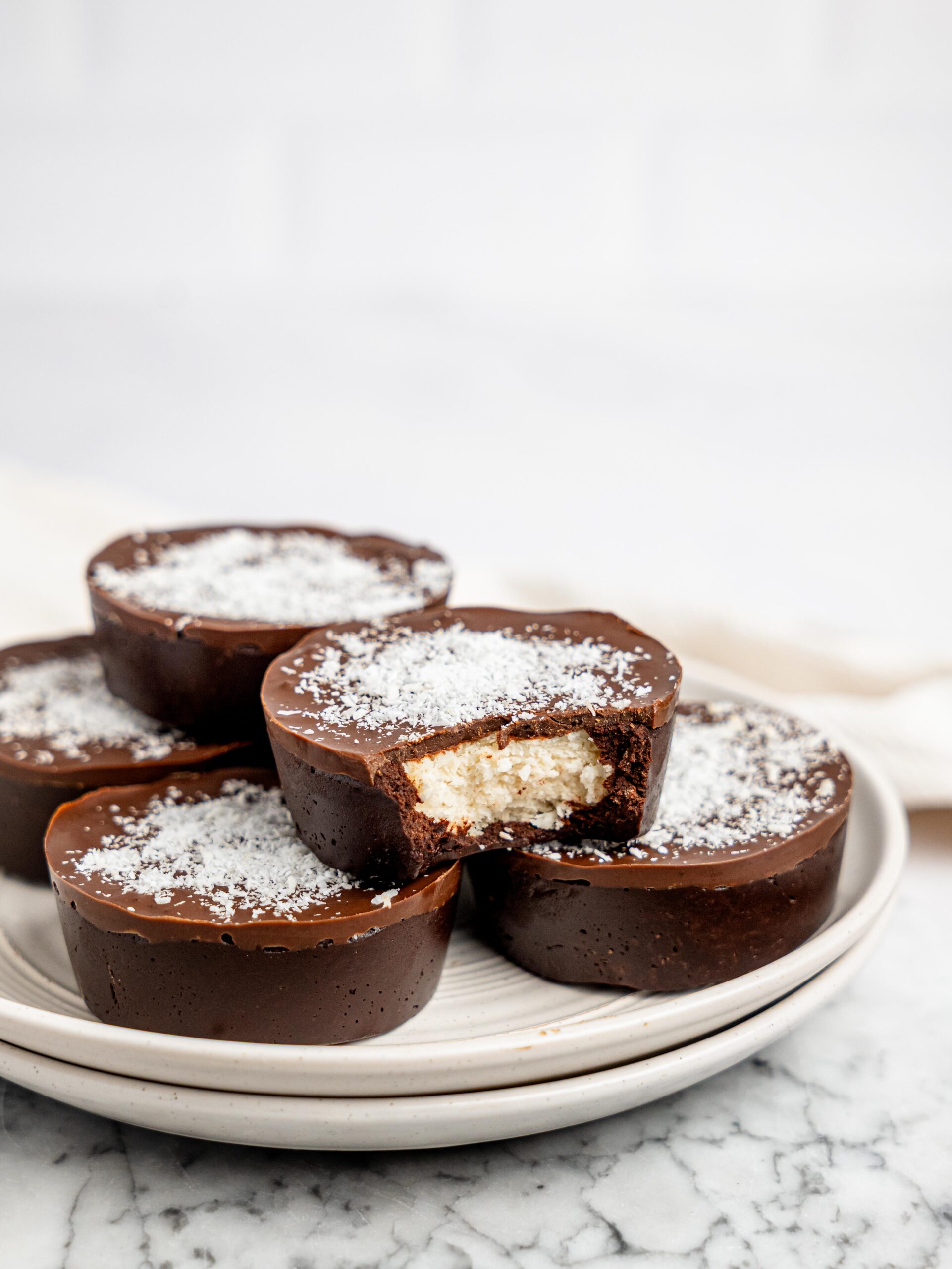 No-bake bounty brownie cups on a white plate.