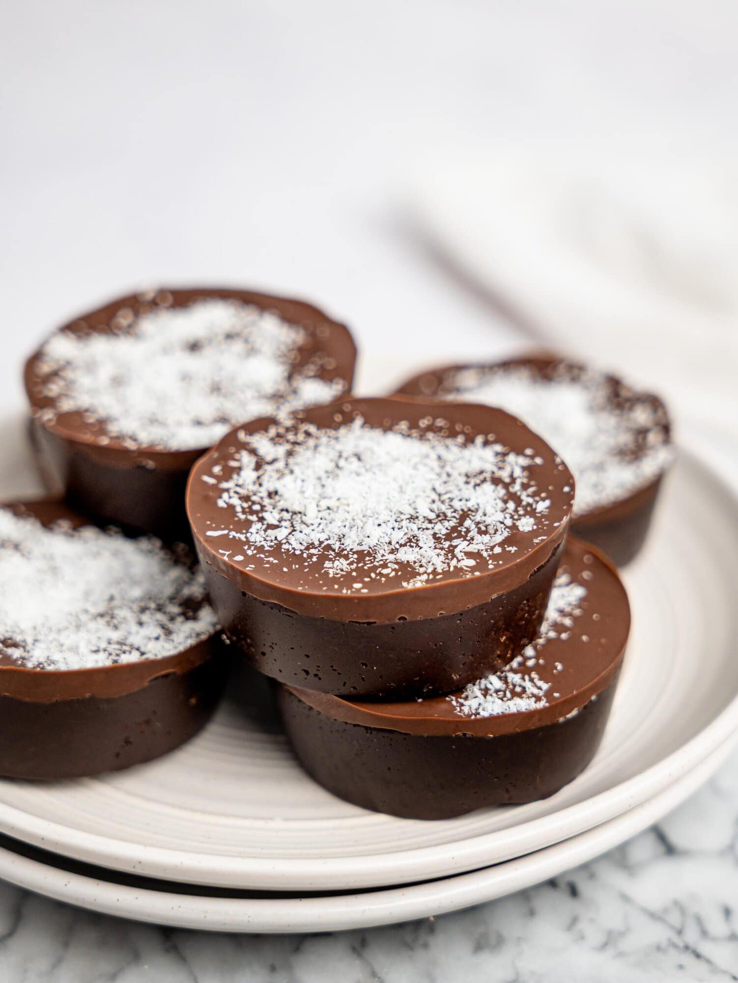 No-bake bounty brownie cups on a white plate.