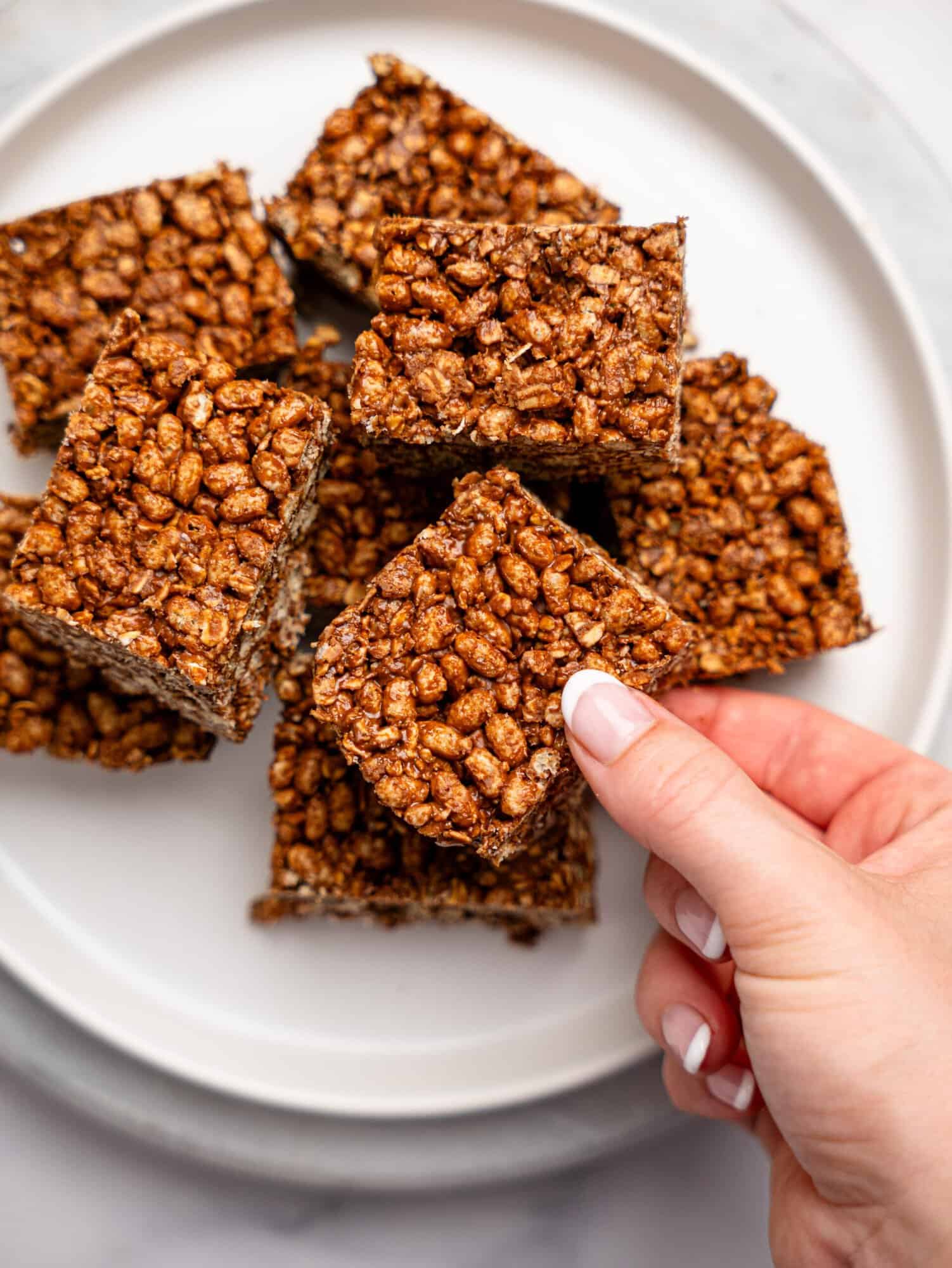 Peanut butter rice krispie squares on a white plate.