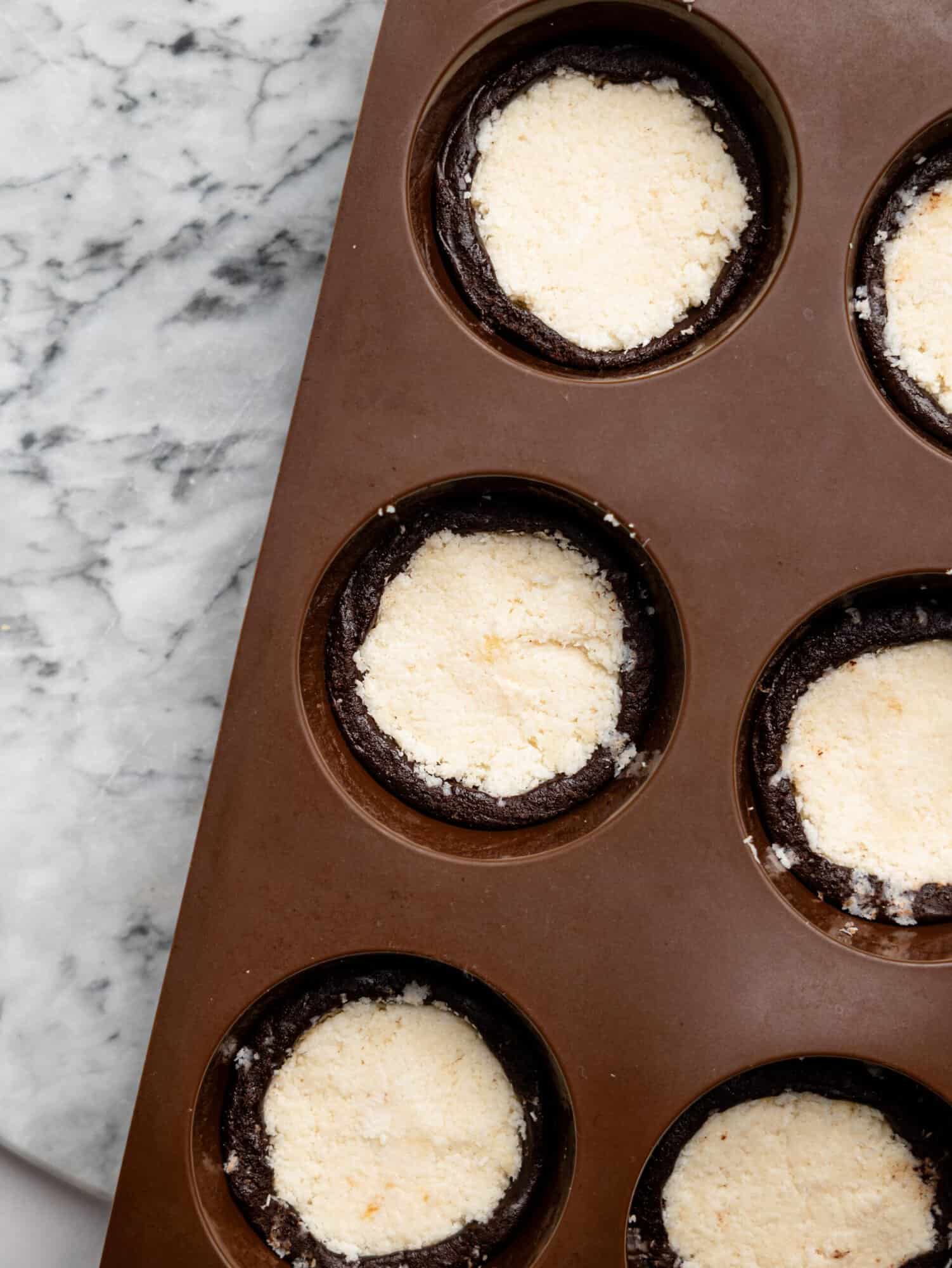 No-bake chocolate brownie cup filled with a creamy coconut filling.