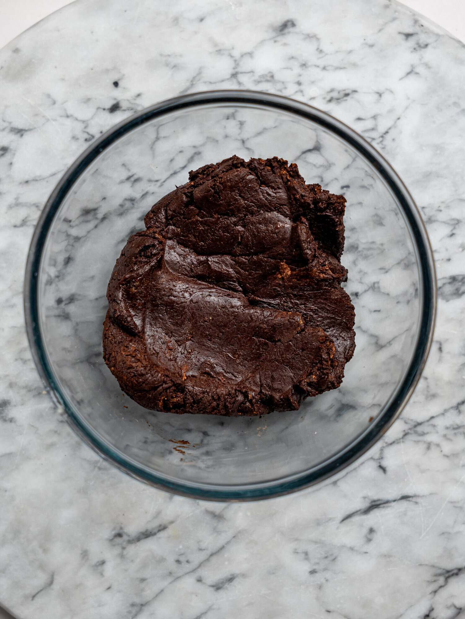 No bake chocolate brownie batter in a glass mixing bowl.