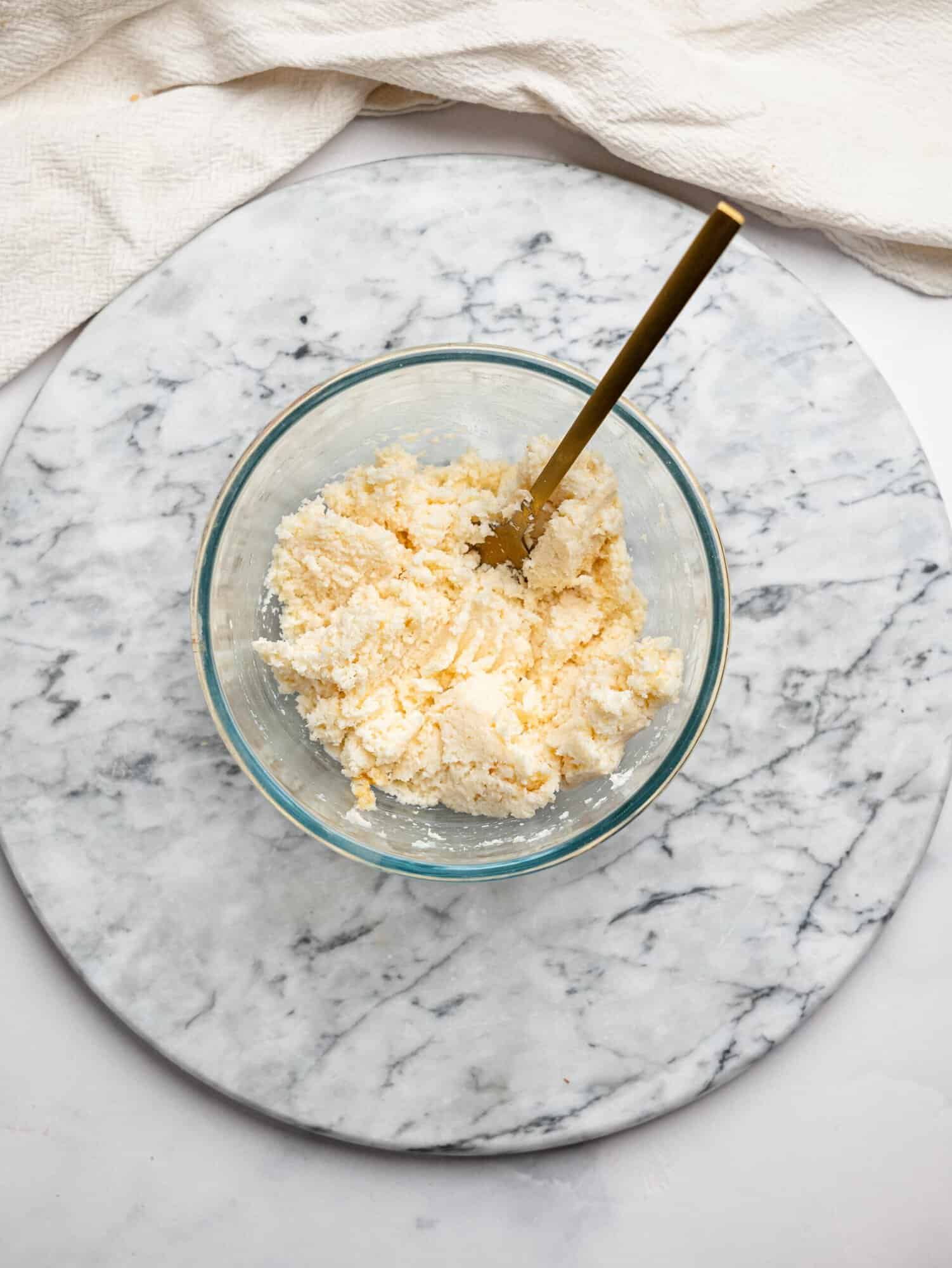 Bounty brownie filling - creamy, coconut filling - in a glass mixing bowl.