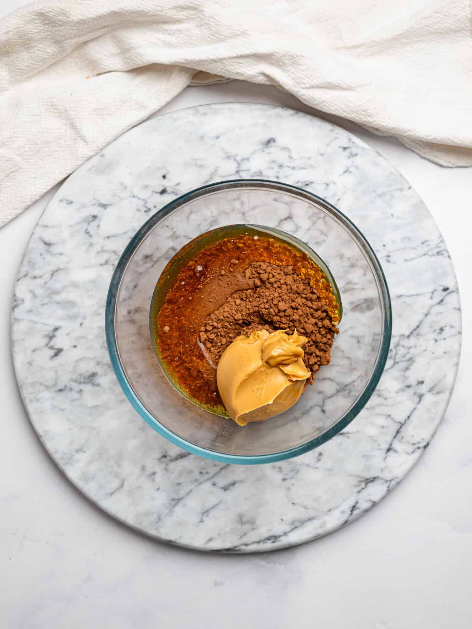 No bake chocolate brownie batter ingredients in a glass mixing bowl.