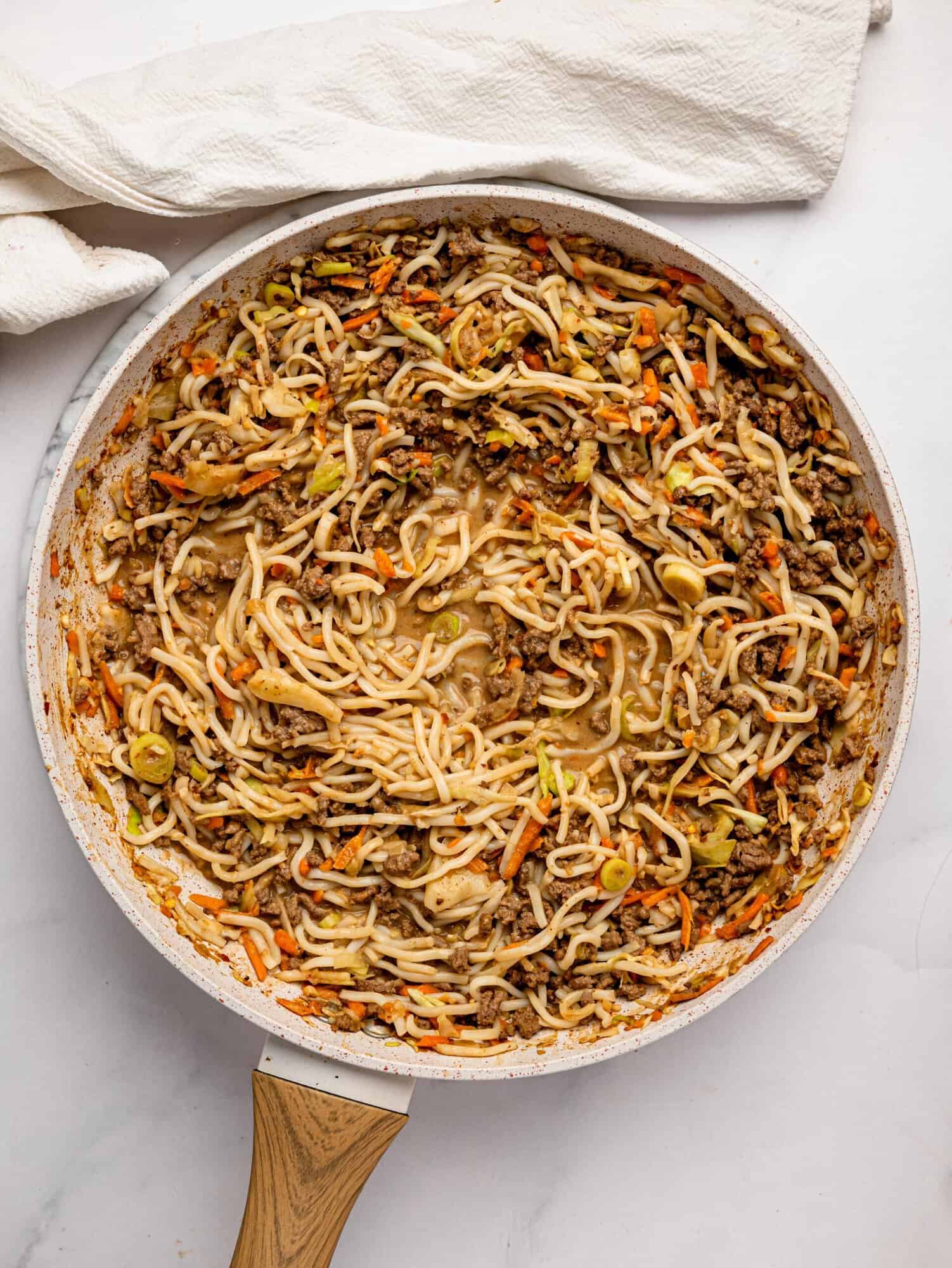 Ramen noodles with ground beef in a frying pan.