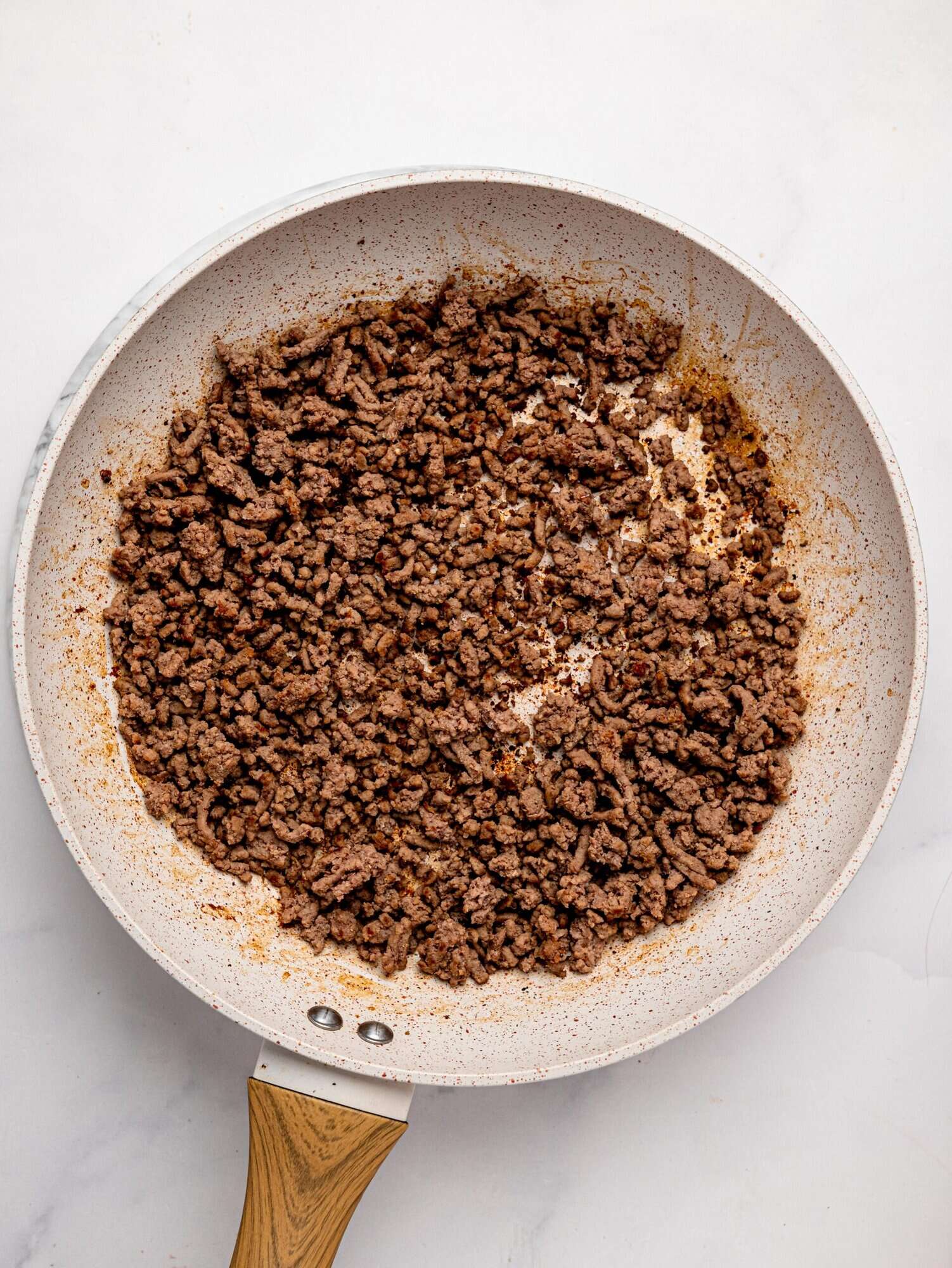 Cooked extra lean beef mince in a frying pan.