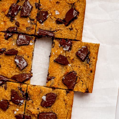 Bird's eye view of healthy cookie bars on a sheet of white parchment paper.
