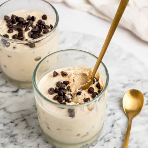 Ingredients needed to make Cottage Cheese Cookie Dough Mousse including cottage cheese, nut butter, oat flour, coconut sugar, vanilla extract, and dark chocolate chips.