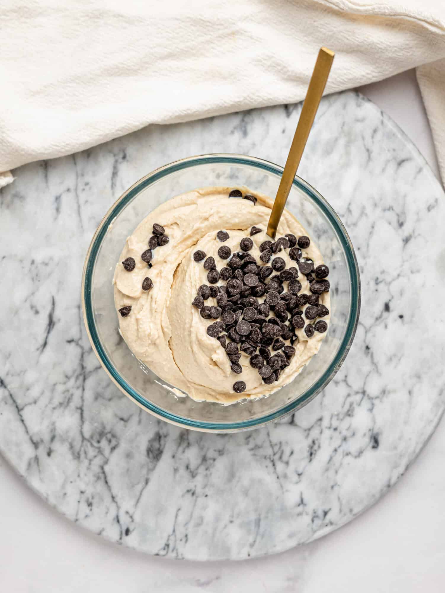 Close-up of Cottage Cheese Cookie Dough Mousse with dark chocolate chips served in a glass dessert cup.