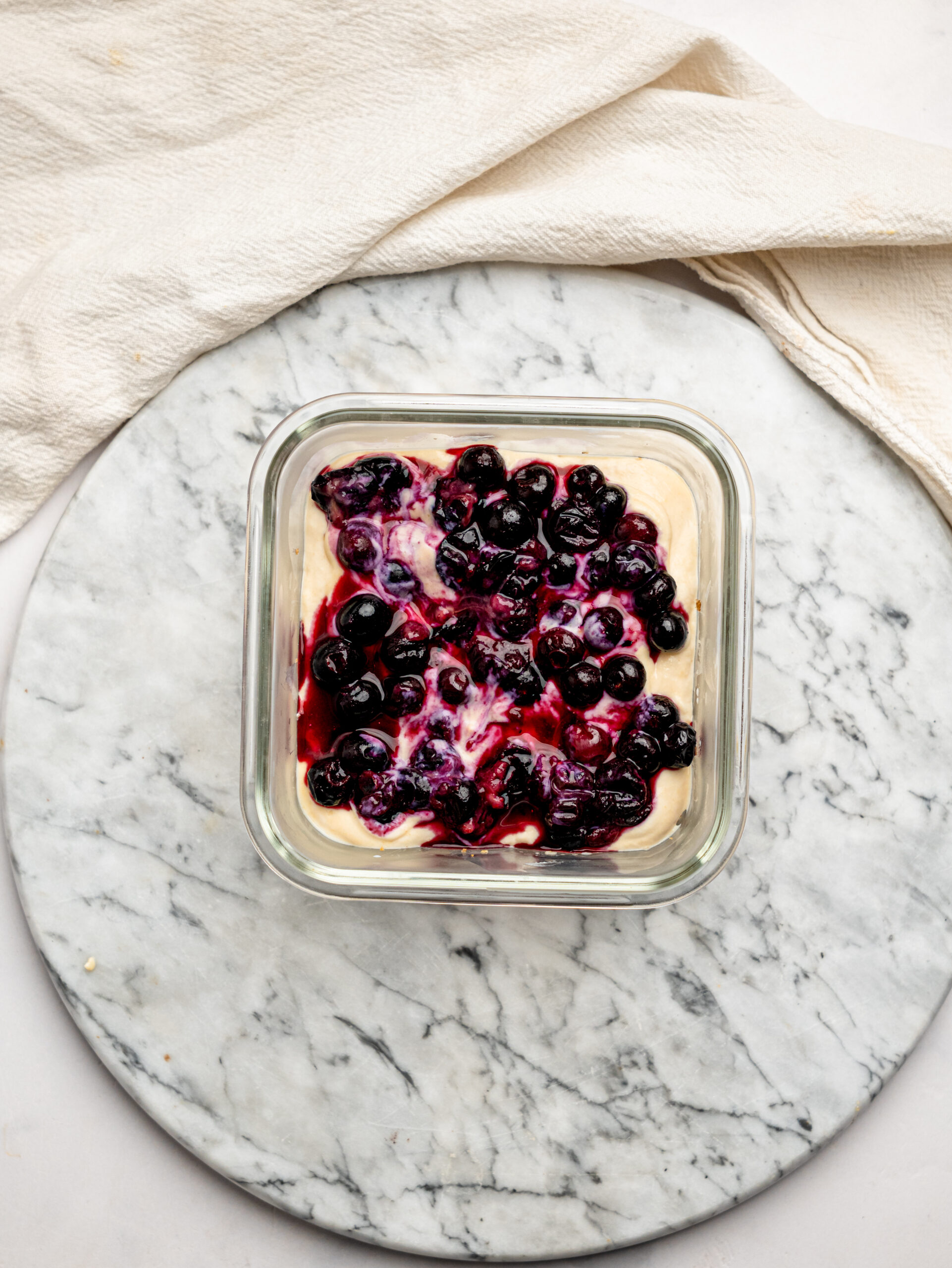 Jammy mixed berry topping spooned over a creamy peanut butter yogurt layer for PB&J Overnight Weetbix.