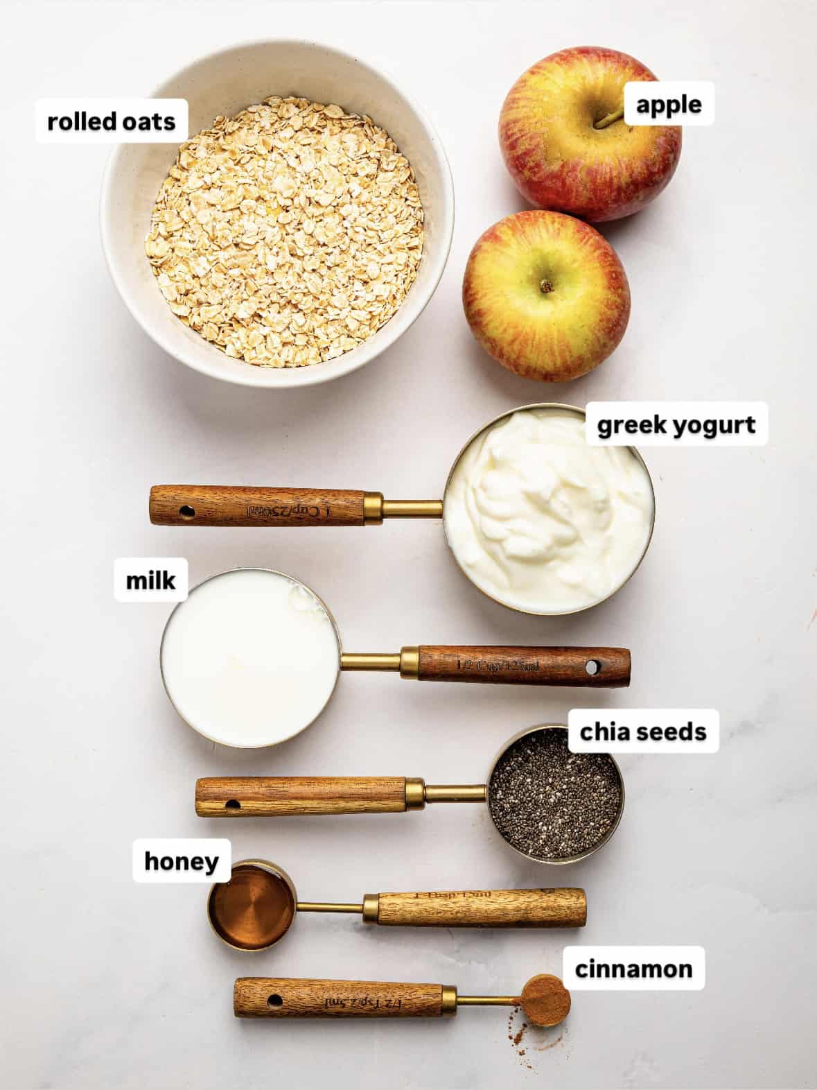 Apple Pie Overnight Oats ingredients including rolled oats, apples, Greek yogurt, milk, chia seeds, honey, and cinnamon.