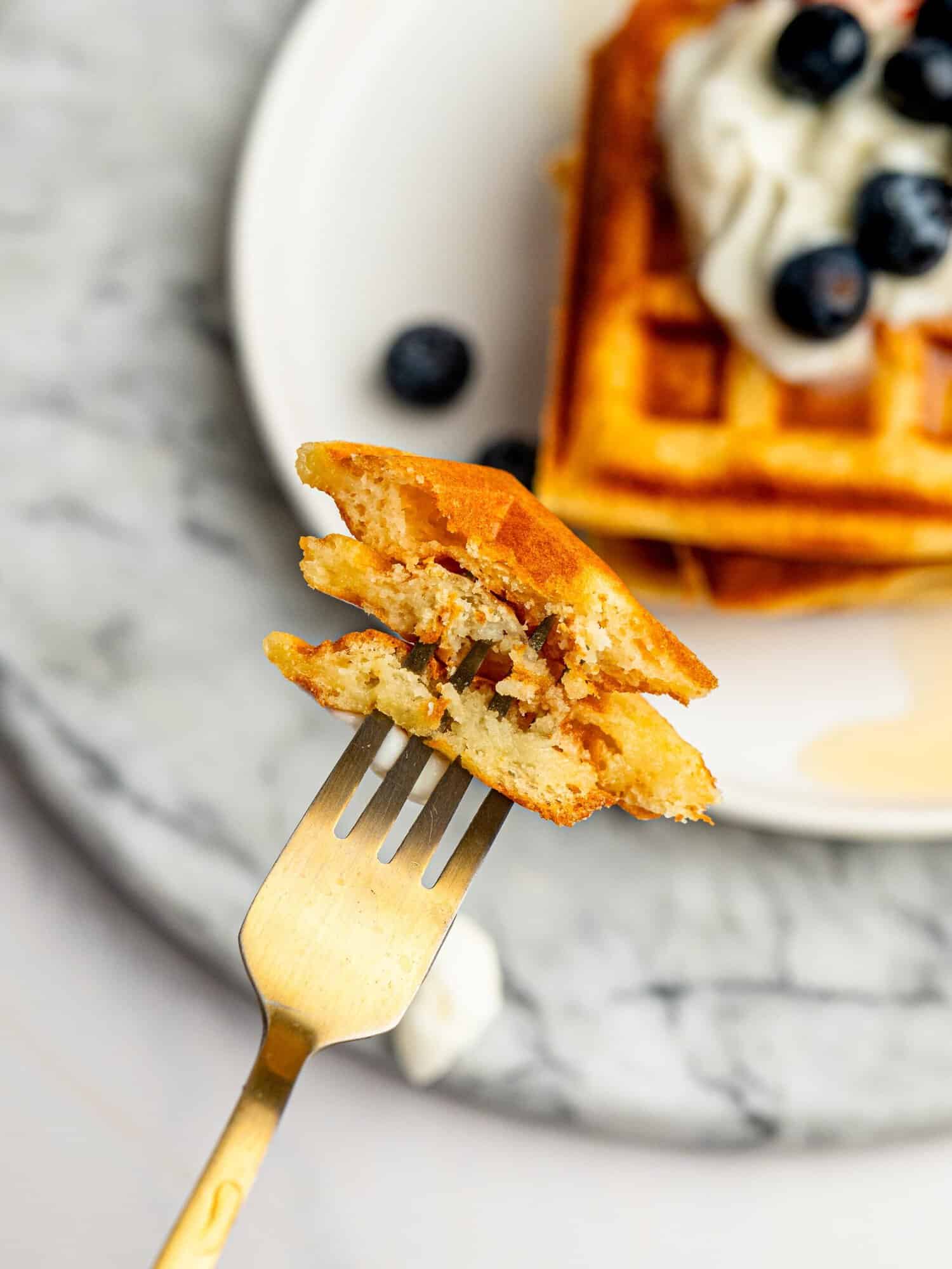 Close-up showing the light, fluffy interior of crispy gluten-free waffles.