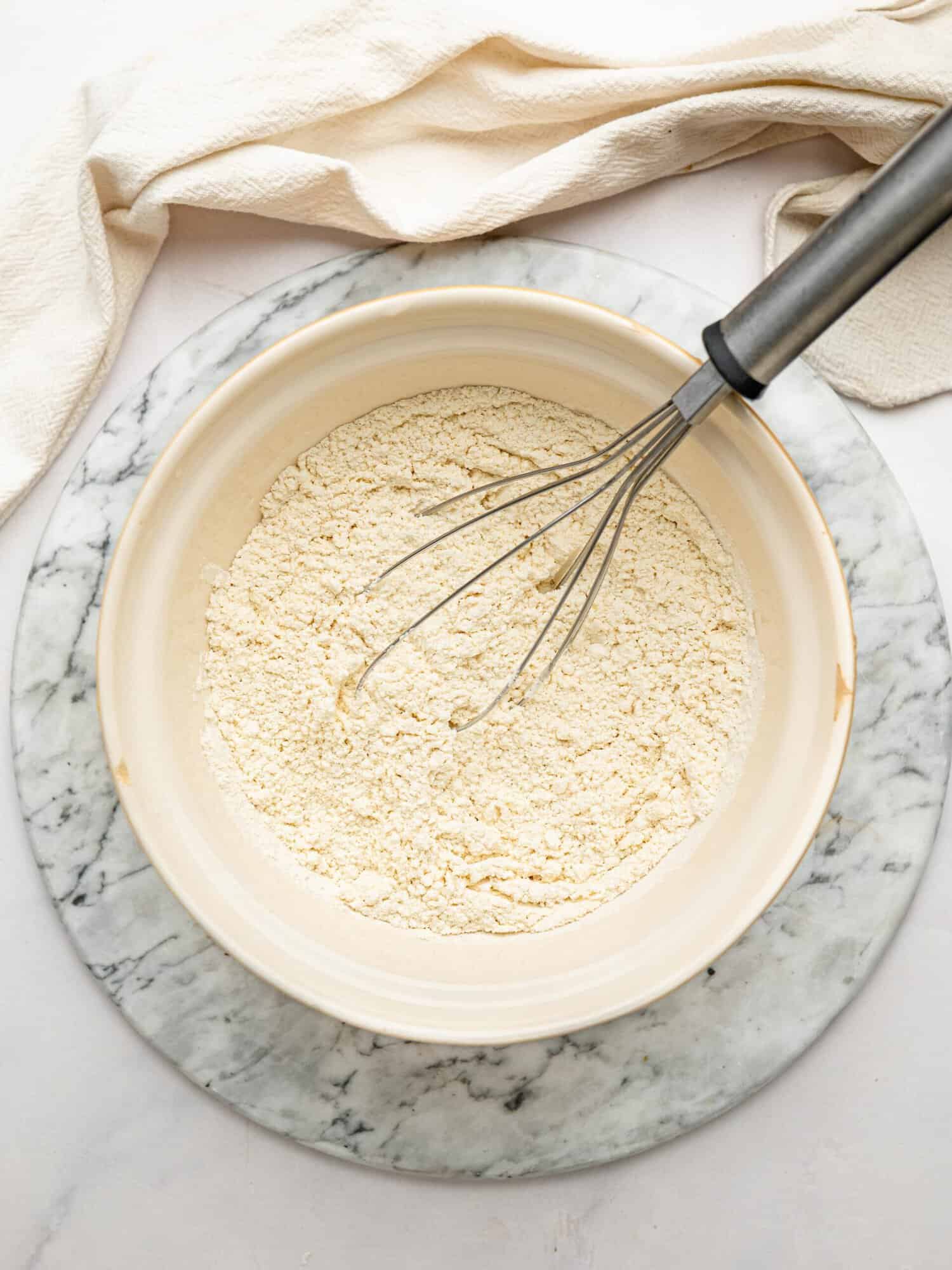 Gluten-free flour blend whisked with baking powder and salt for homemade gluten-free waffles.