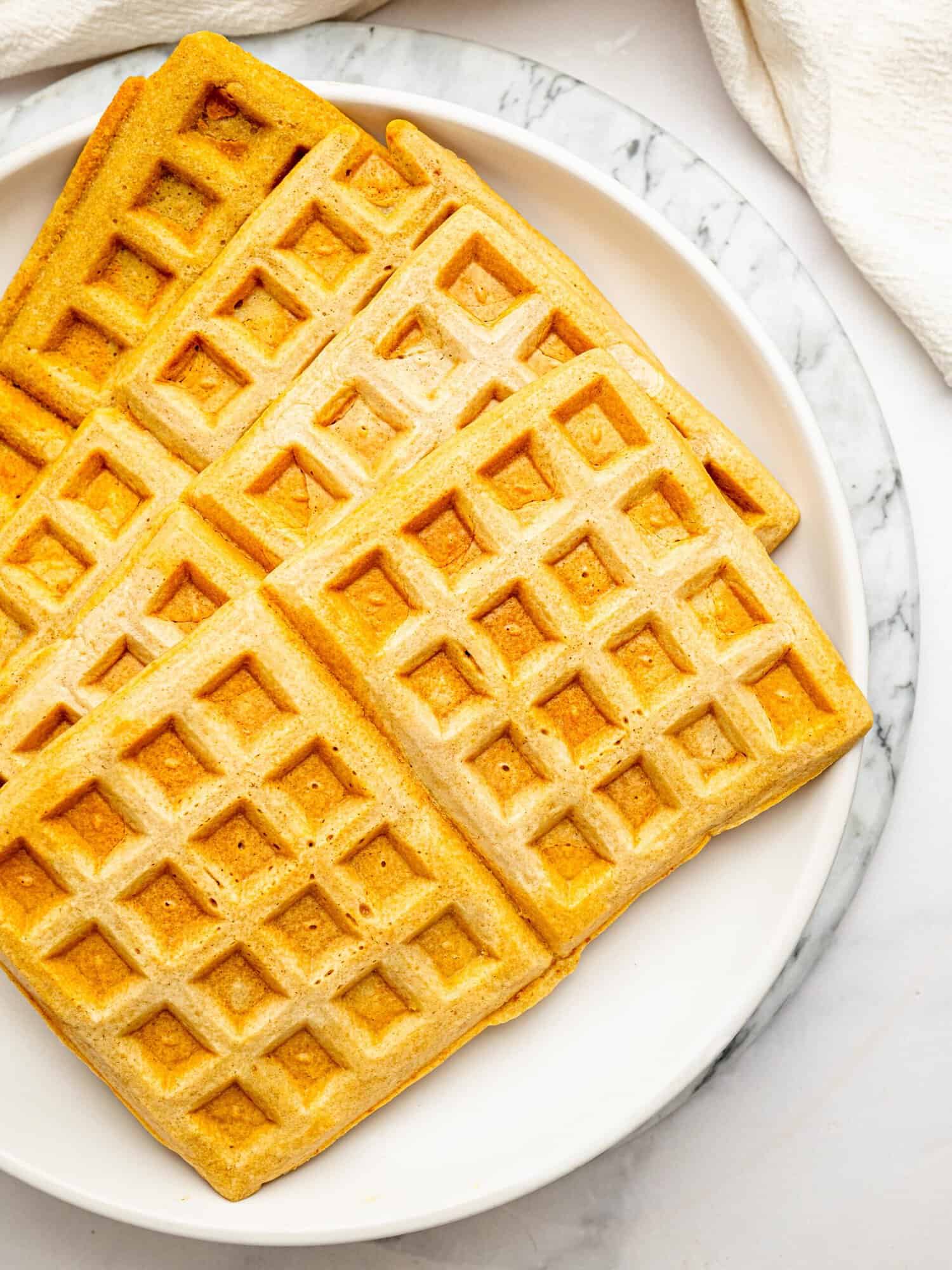 Homemade gluten-free oat flour waffles with a soft, hearty texture.
