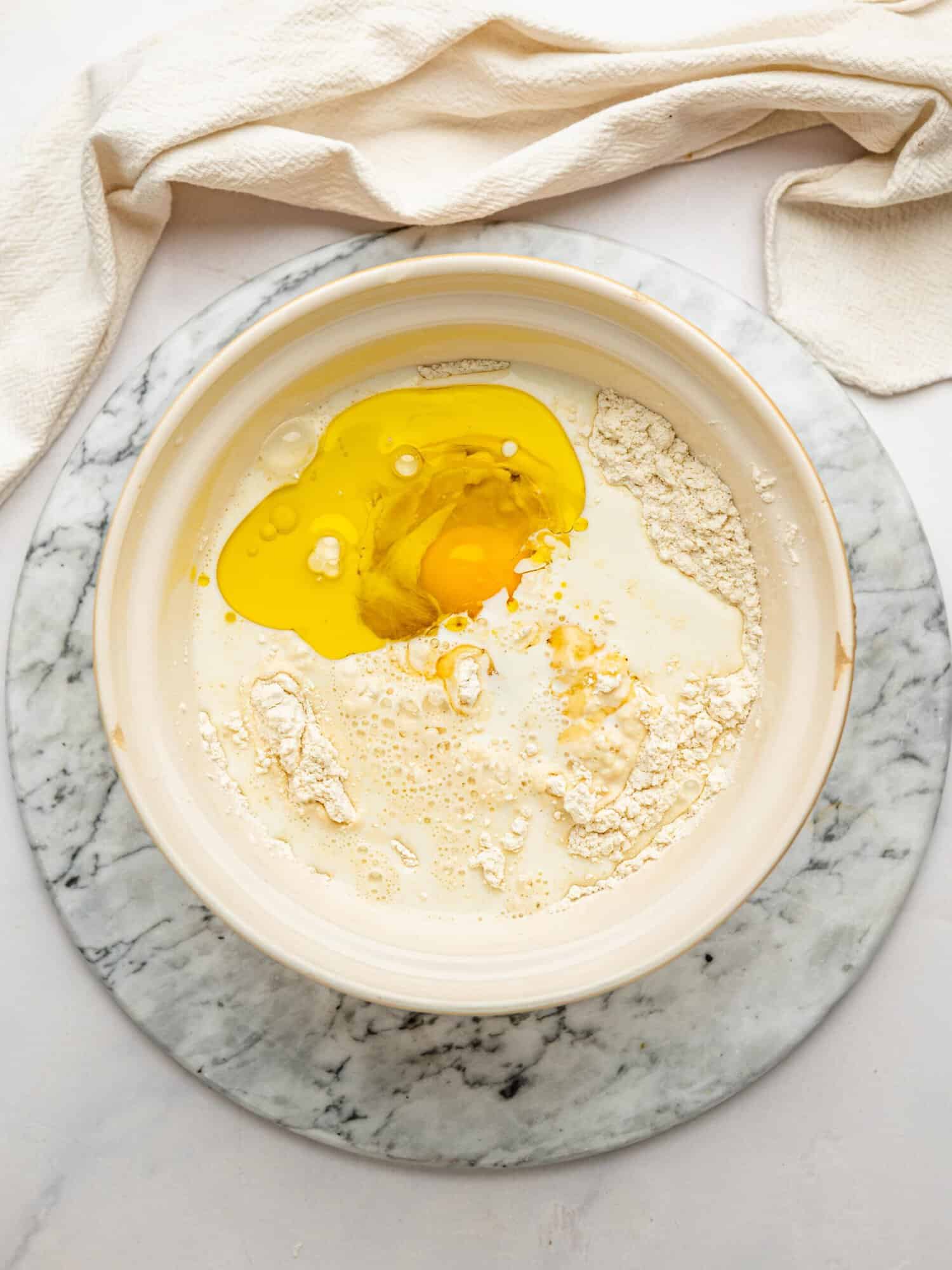 Wet ingredients added to gluten-free flour for an easy one bowl gluten free waffle recipe.