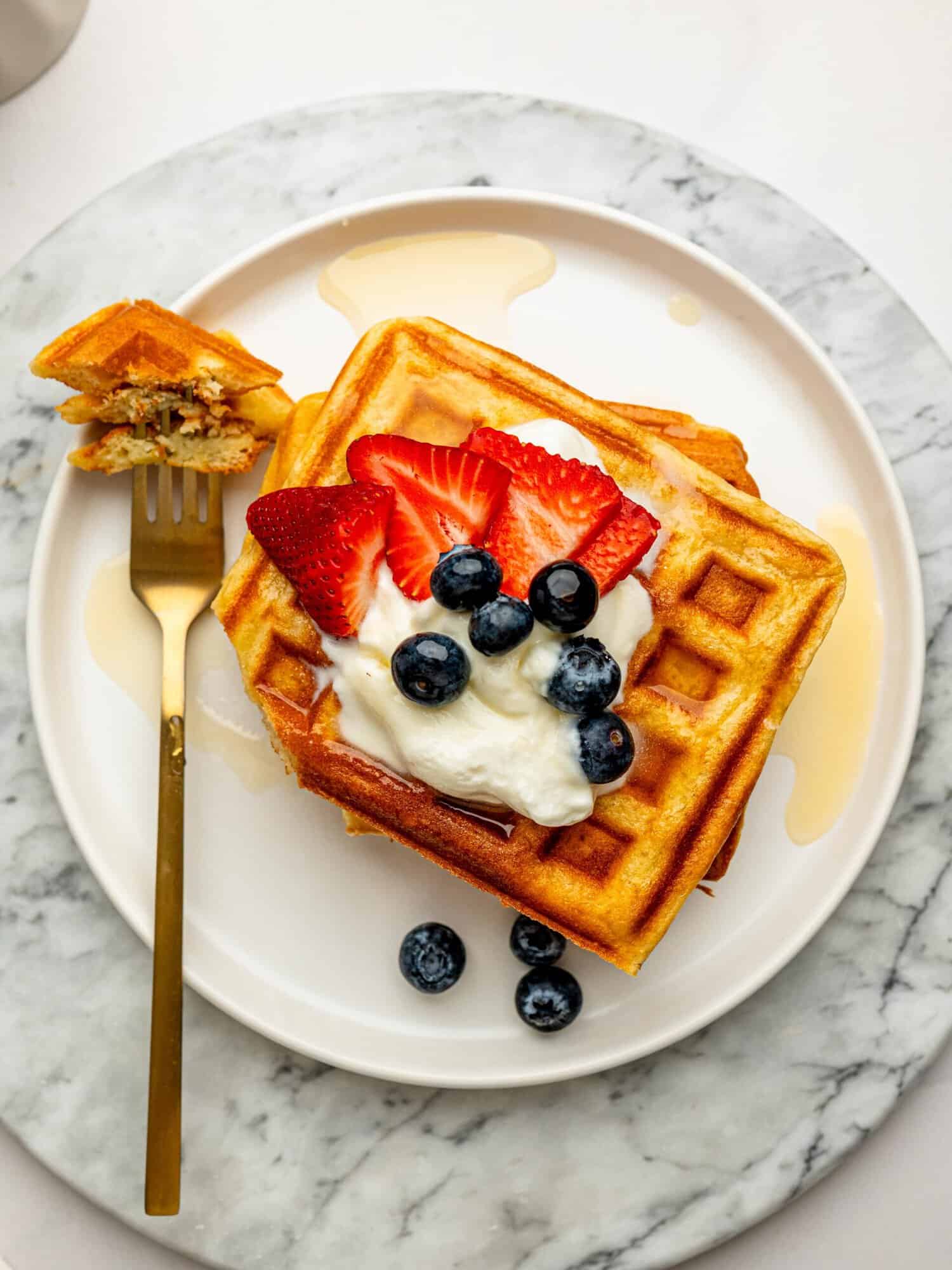 Gluten Free Waffle Recipe served with Greek yogurt, fresh berries, and honey.