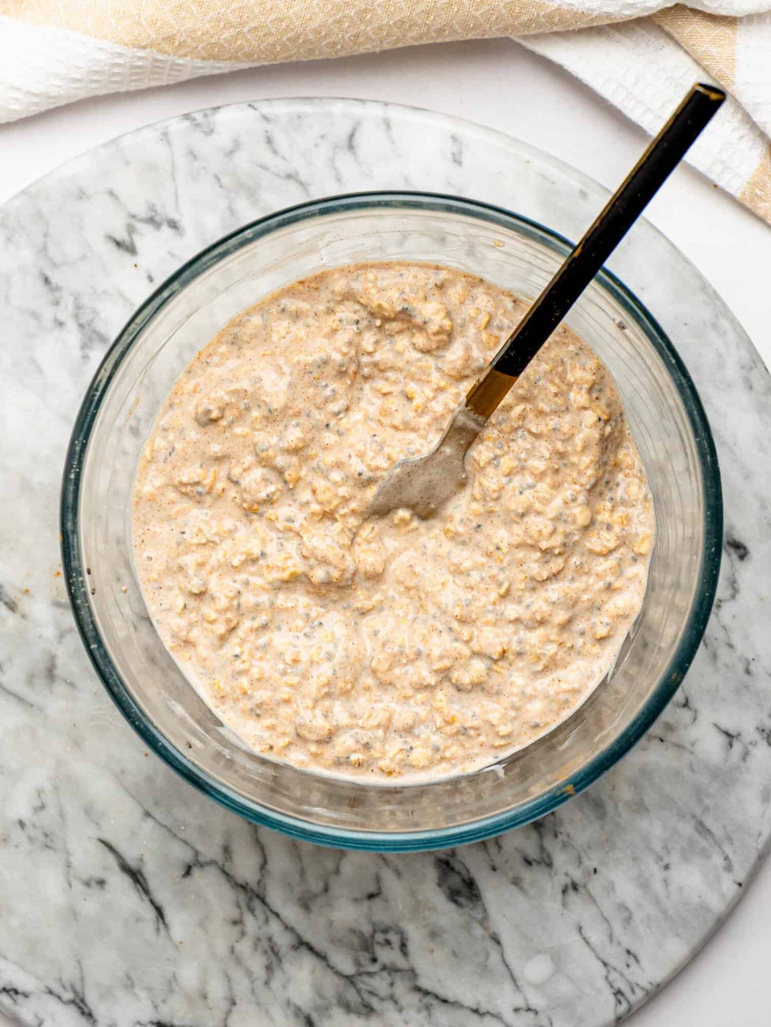 Creamy overnight oat mixture with Greek yogurt, oats, chia seeds, milk, honey, and cinnamon.