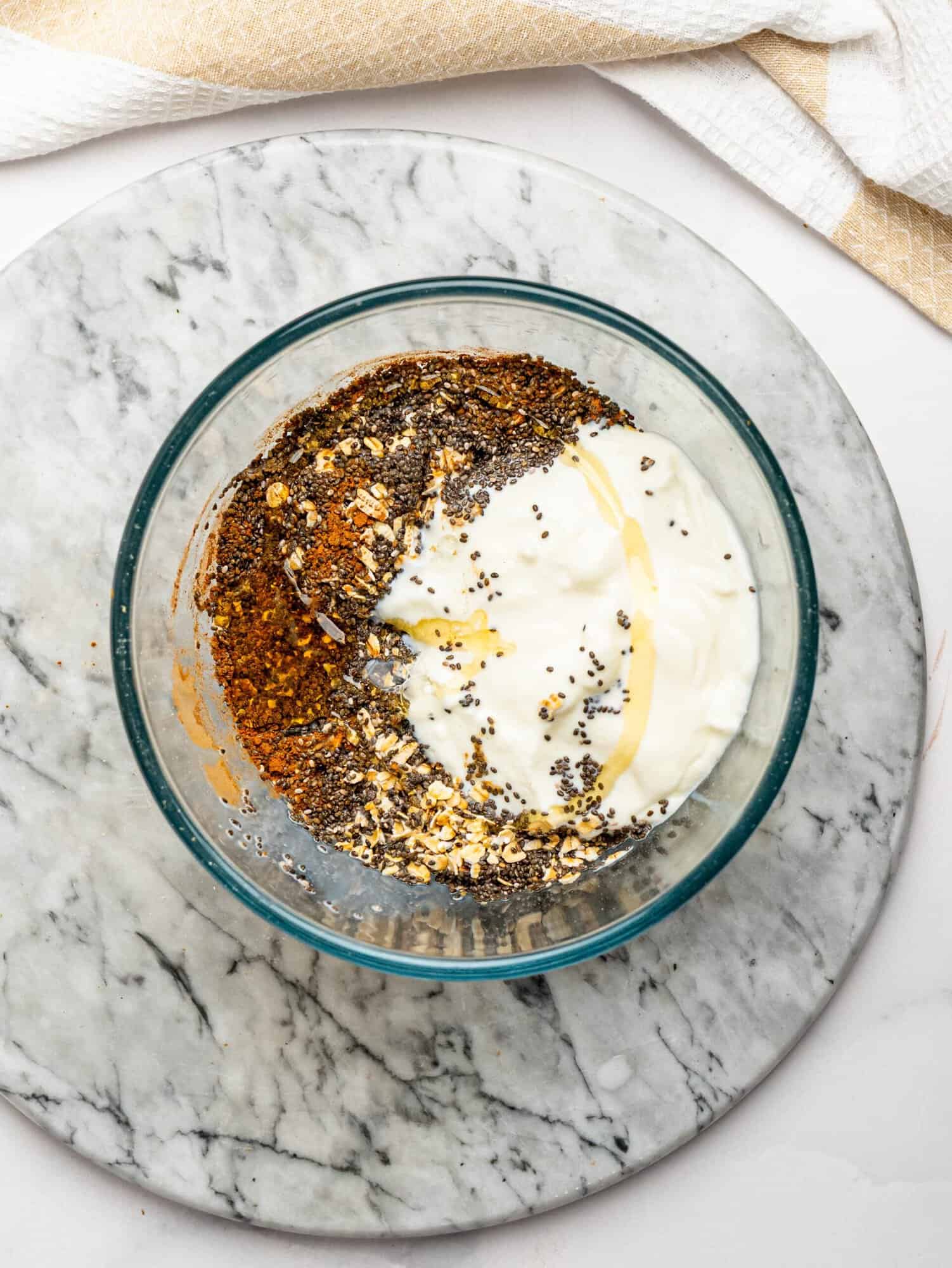 Overhead view of overnight oats ingredients mixed together in a bowl.