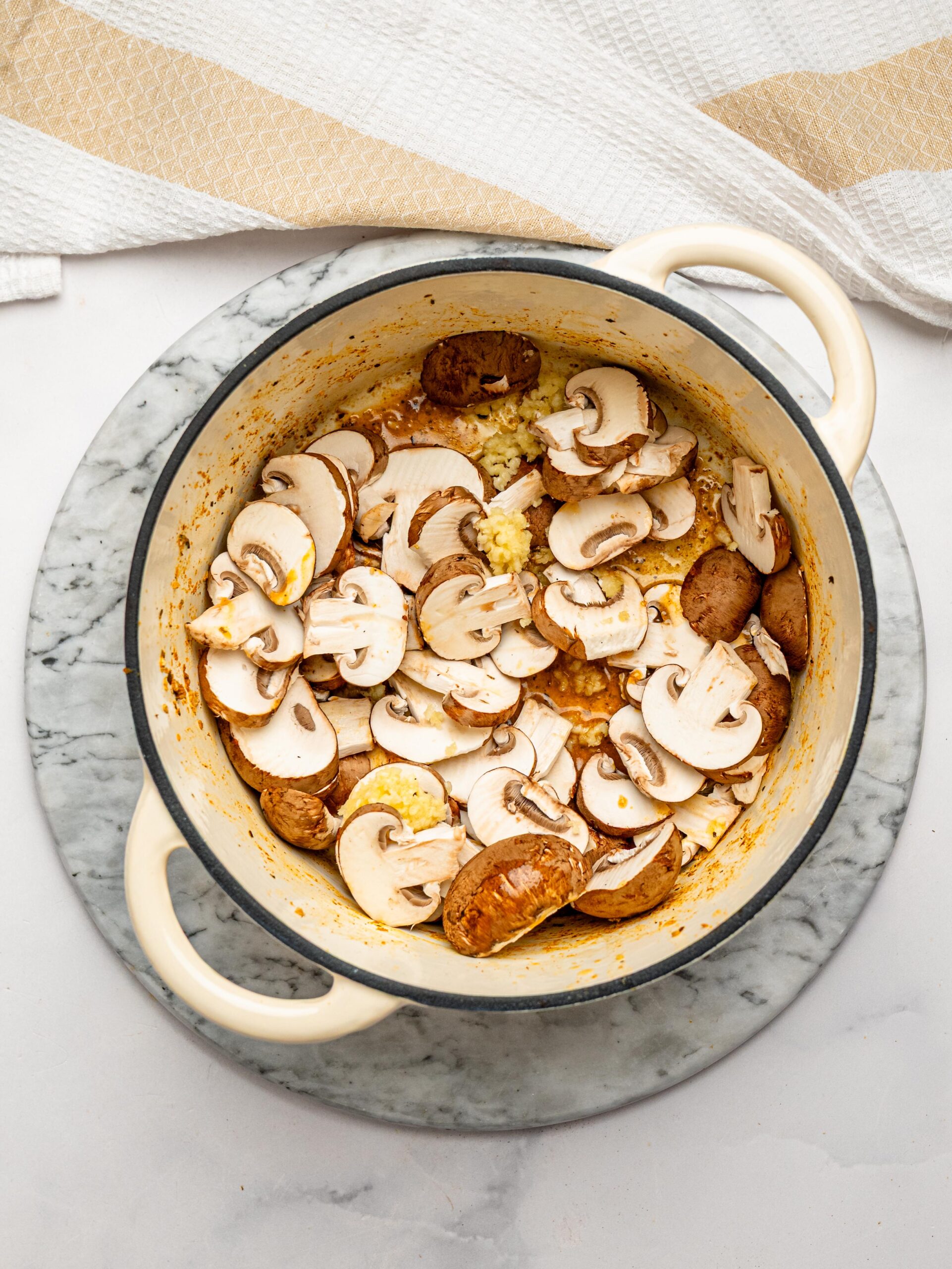 Fresh mushrooms and garlic cooking in the pot before adding the pasta.