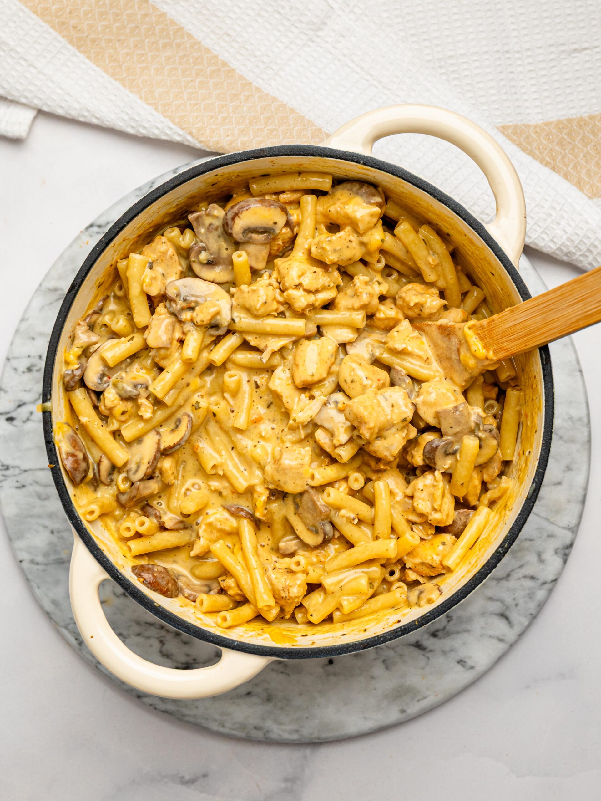 Creamy one pot mac and cheese ready to serve with tender chicken and mushrooms.