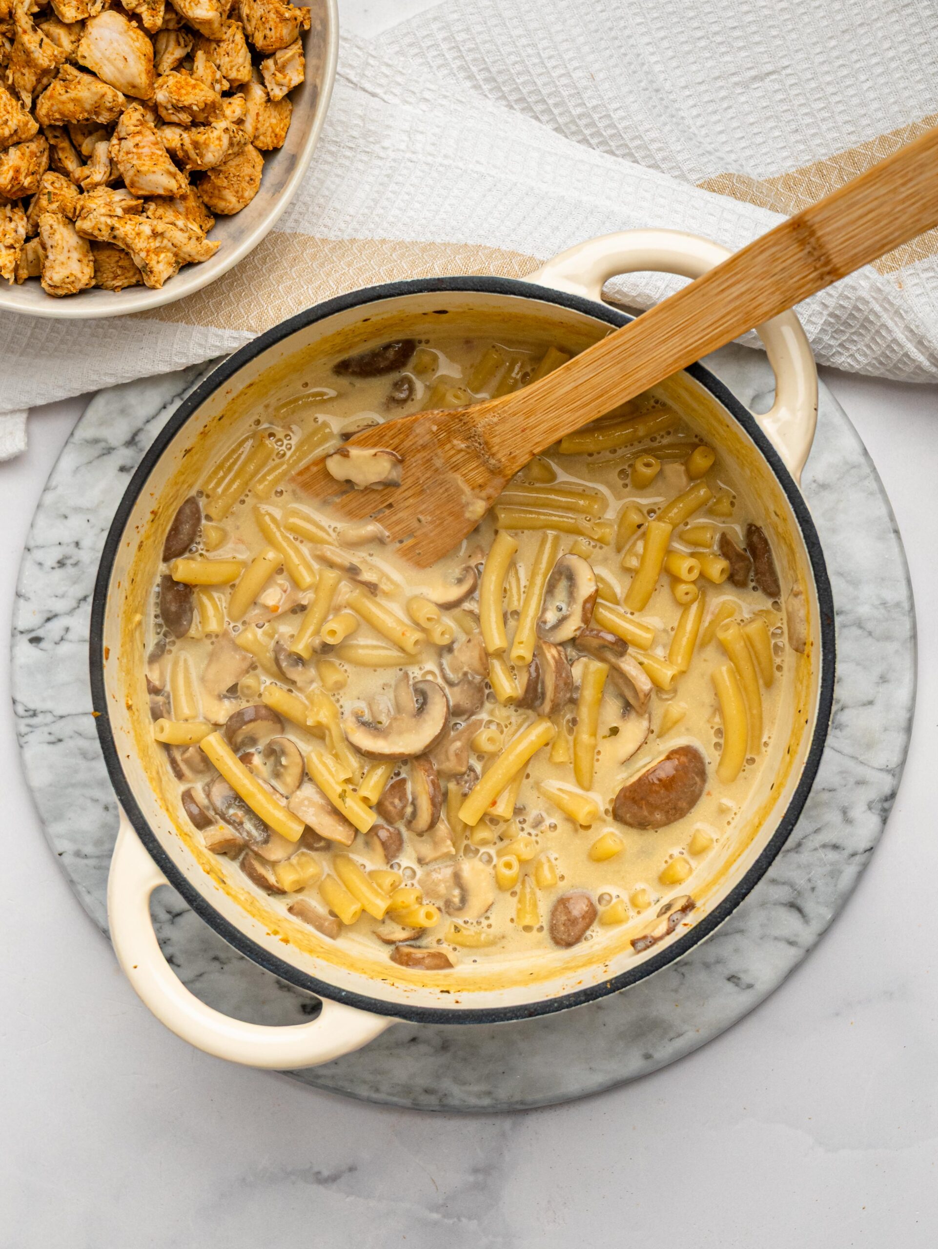 Macaroni simmering in a creamy sauce for homemade one pot mac and cheese.