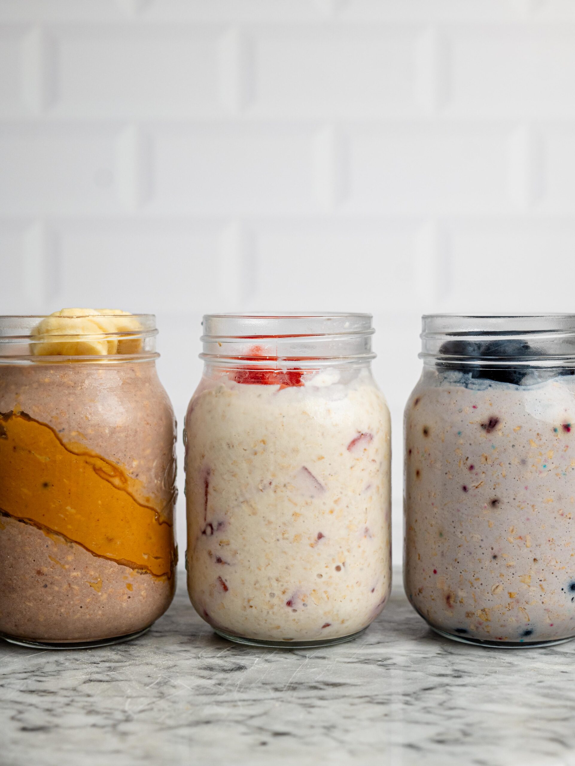 jars of overnight oats Three jars of overnight oats made with different flavors of protein powder.