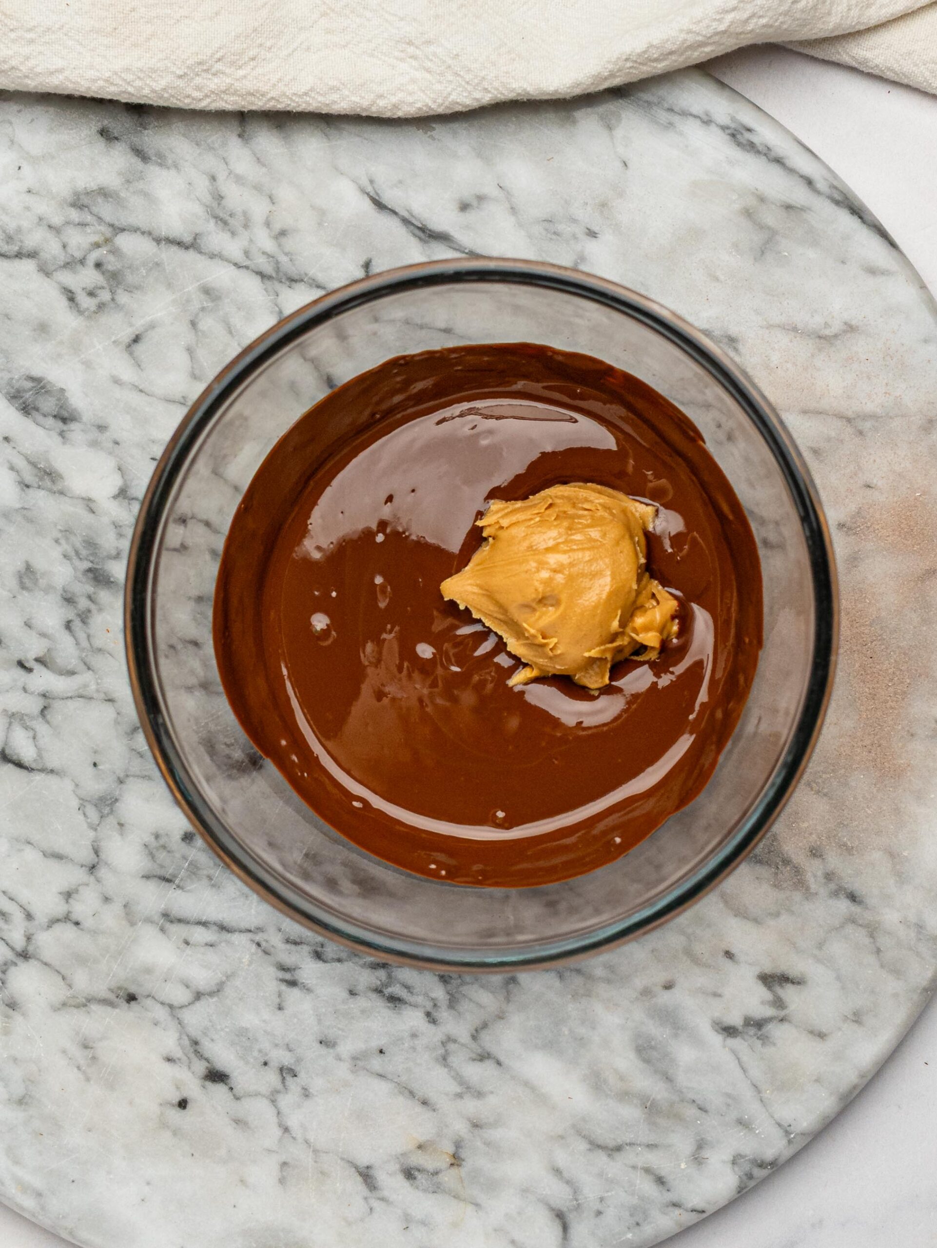 Dark chocolate and peanut butter in a bowl before being melted together for the topping.