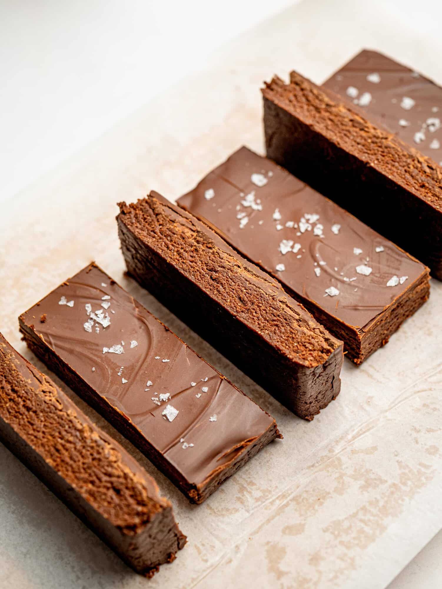 Sliced healthy chocolate protein bars arranged on parchment paper ready for serving.