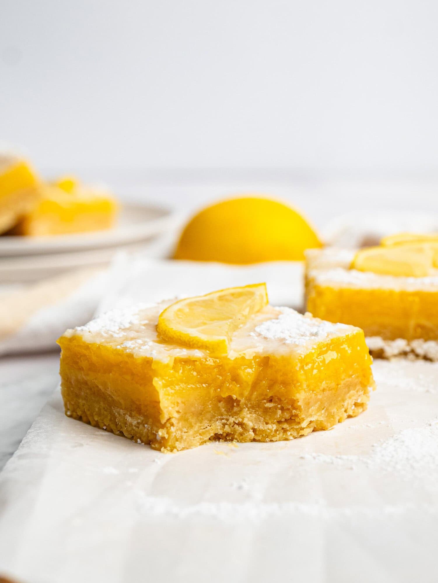 Close-up of a gluten-free lemon bar showing the creamy lemon filling and shortbread crust.