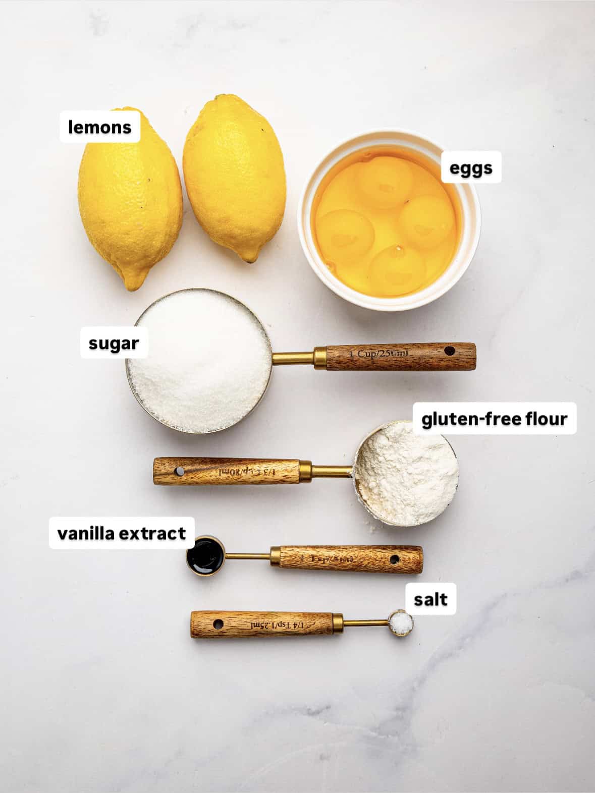 Ingredients for gluten free lemon bars including lemons, eggs, sugar and flour.