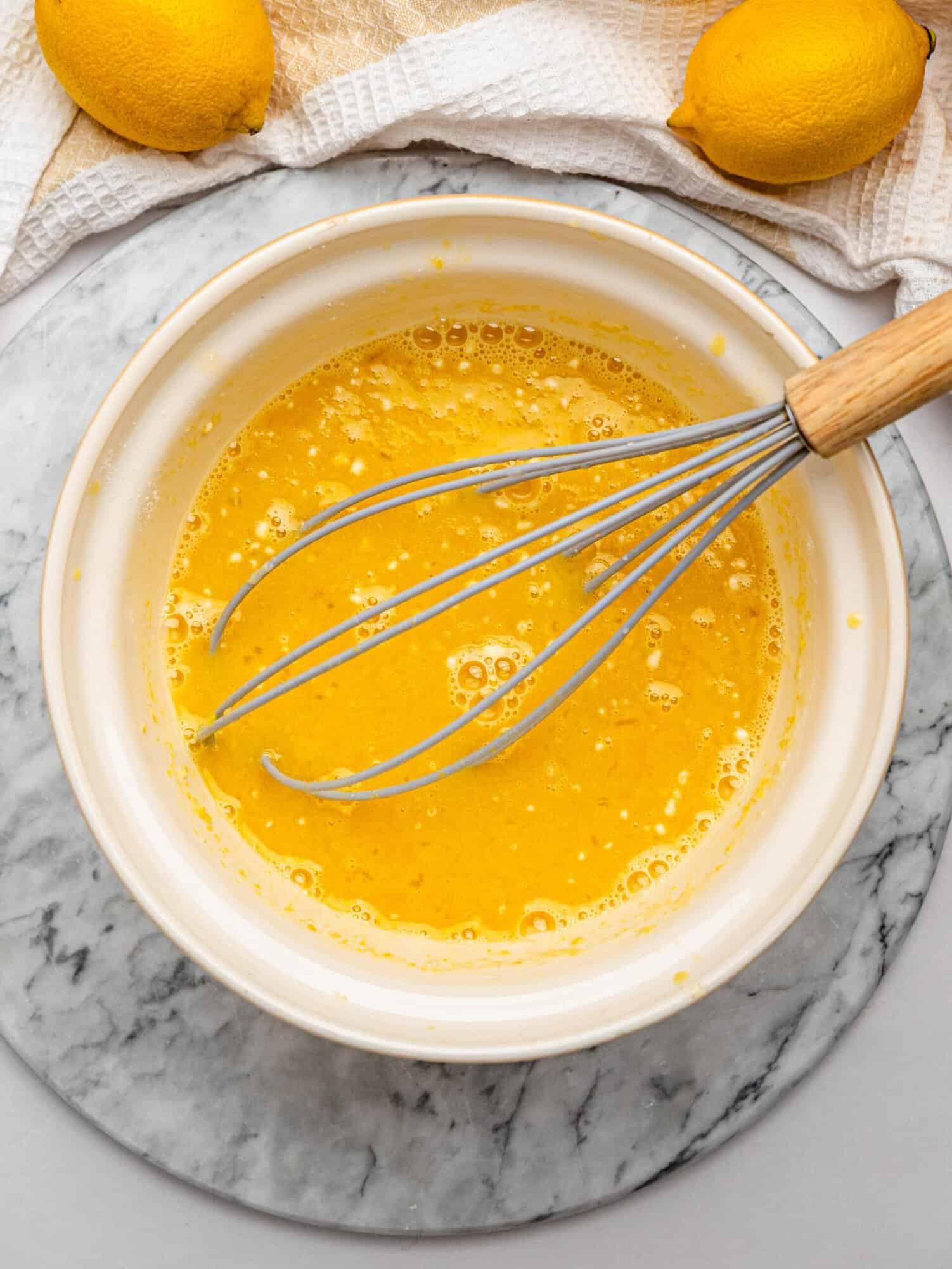 Lemon filling whisked together in a bowl.