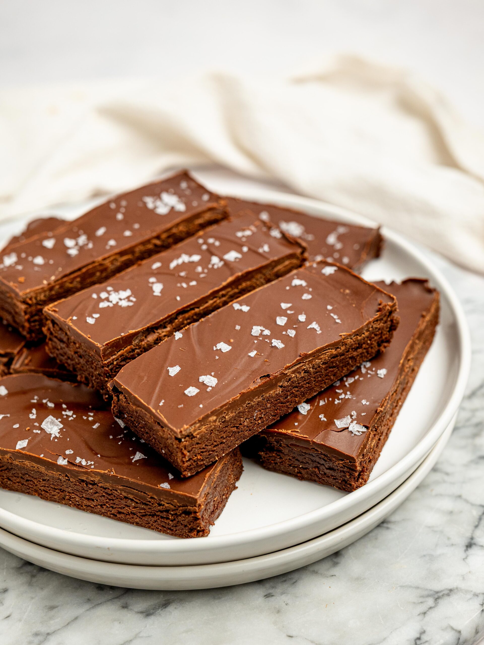 Healthy homemade protein bars arranged on a plate with a dark chocolate topping.