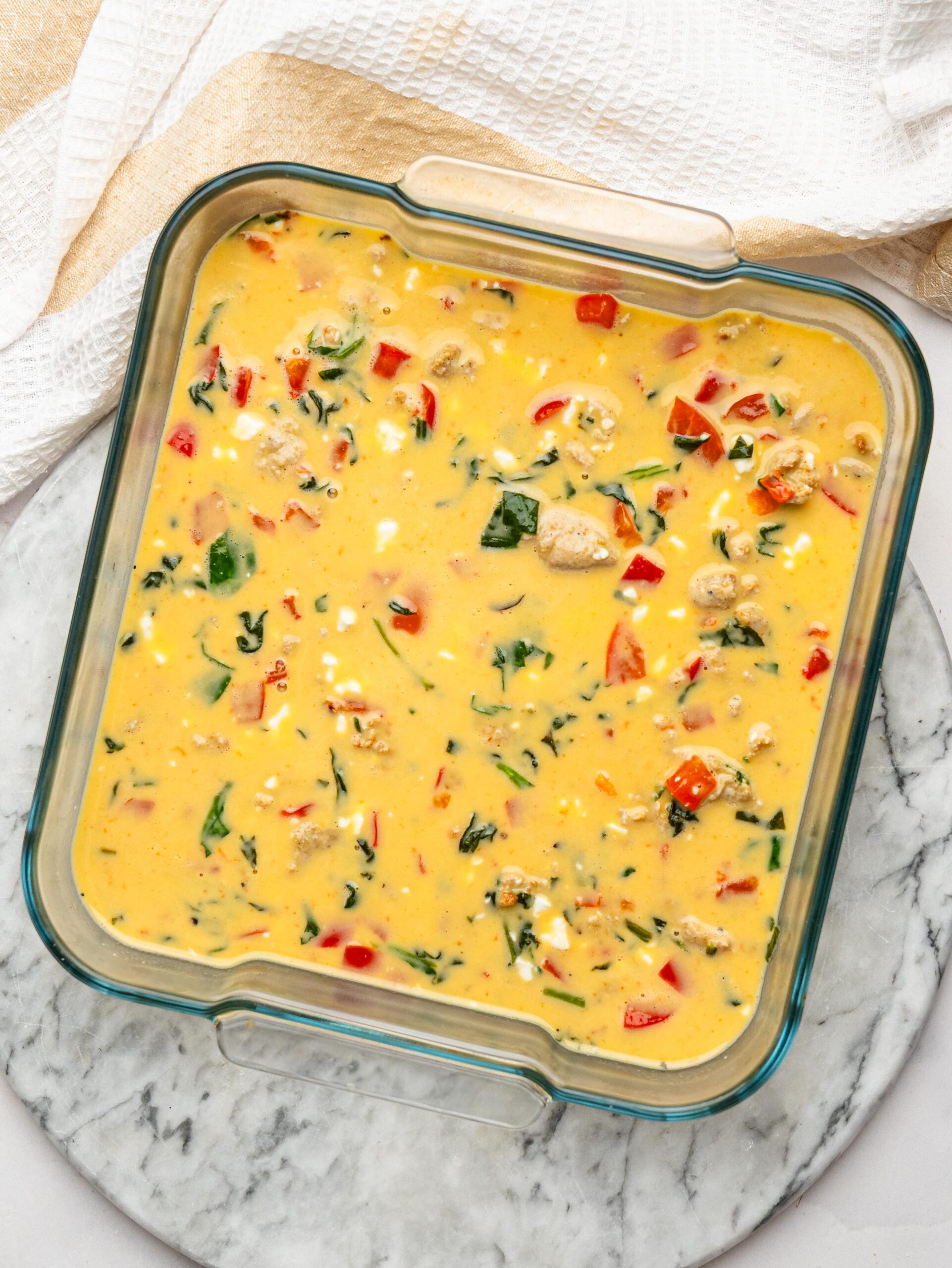 Egg mixture combined with cooked sausage, spinach, bell pepper and cottage cheese.