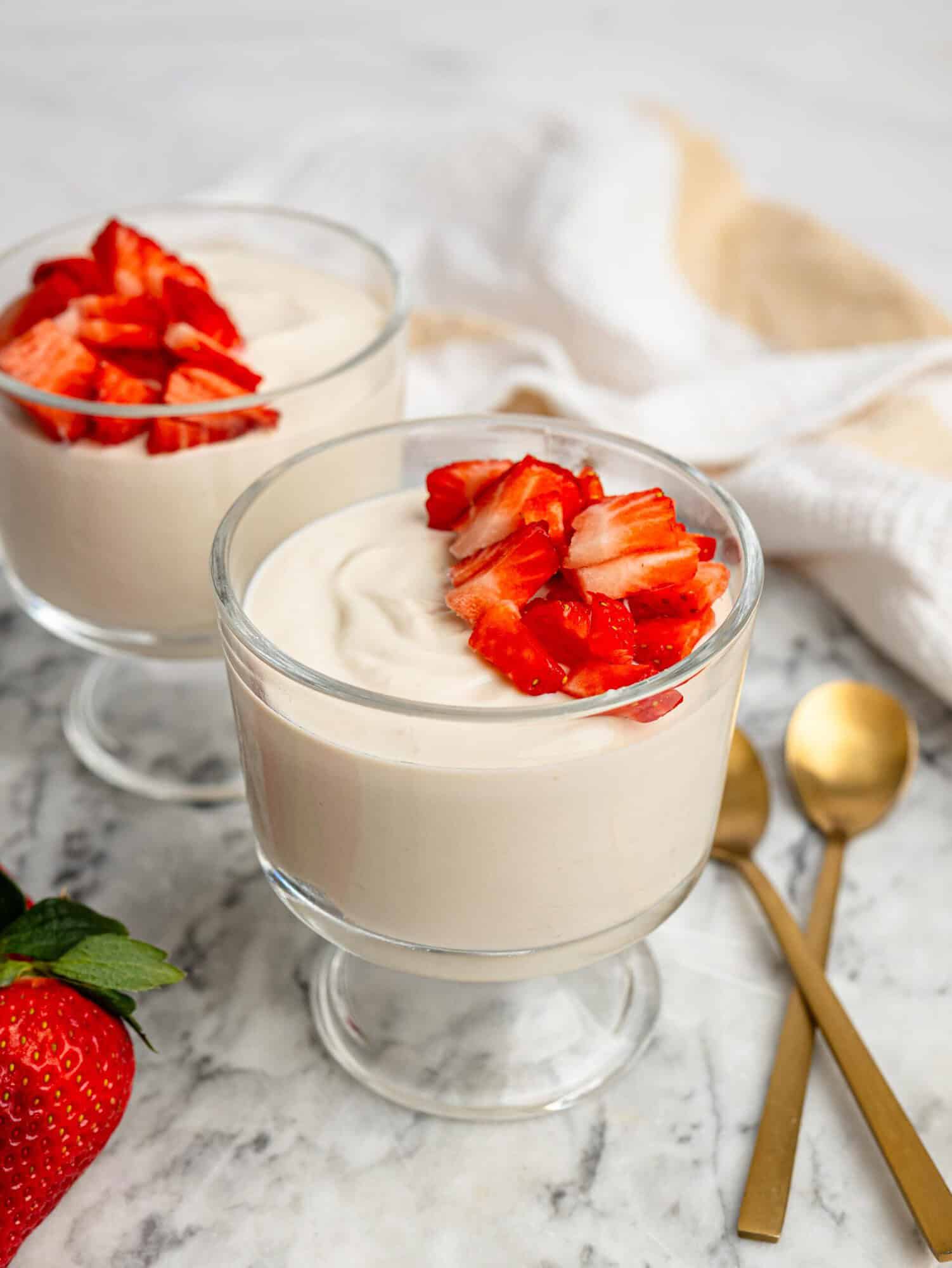 Vanilla protein pudding topped with fresh strawberries.