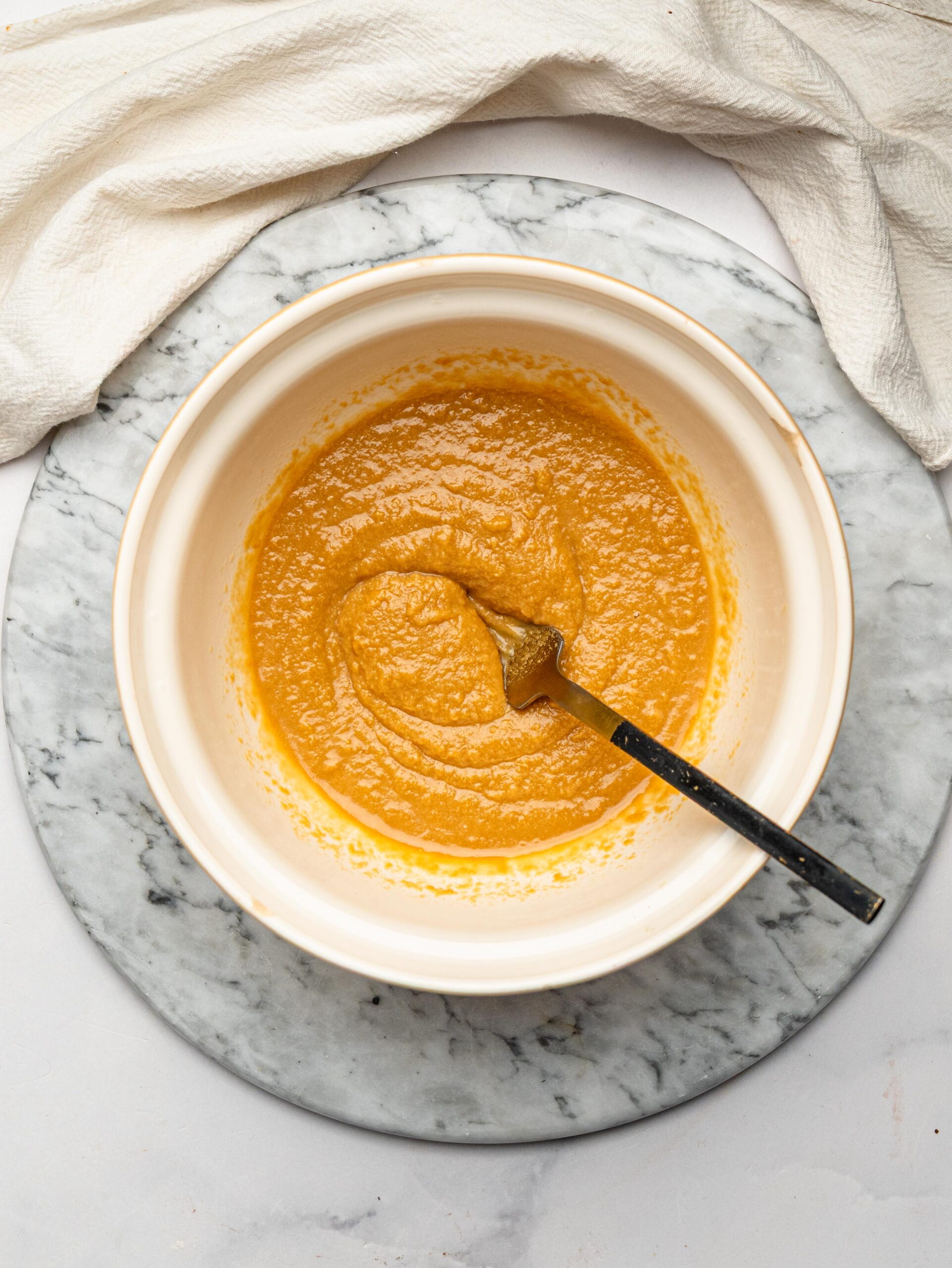 Honey and natural peanut butter mixed together to make the base for homemade chocolate protein bars.