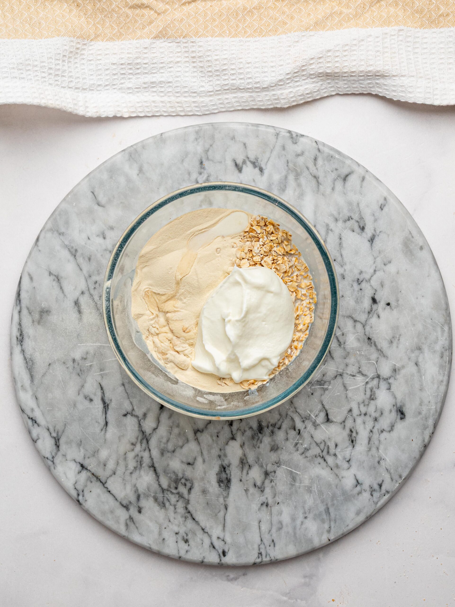 how to make overnight oats Rolled oats, Greek yogurt, milk, and protein powder for making protein overnight oats.