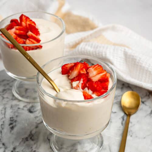 Creamy protein pudding topped with chopped fresh strawberries.