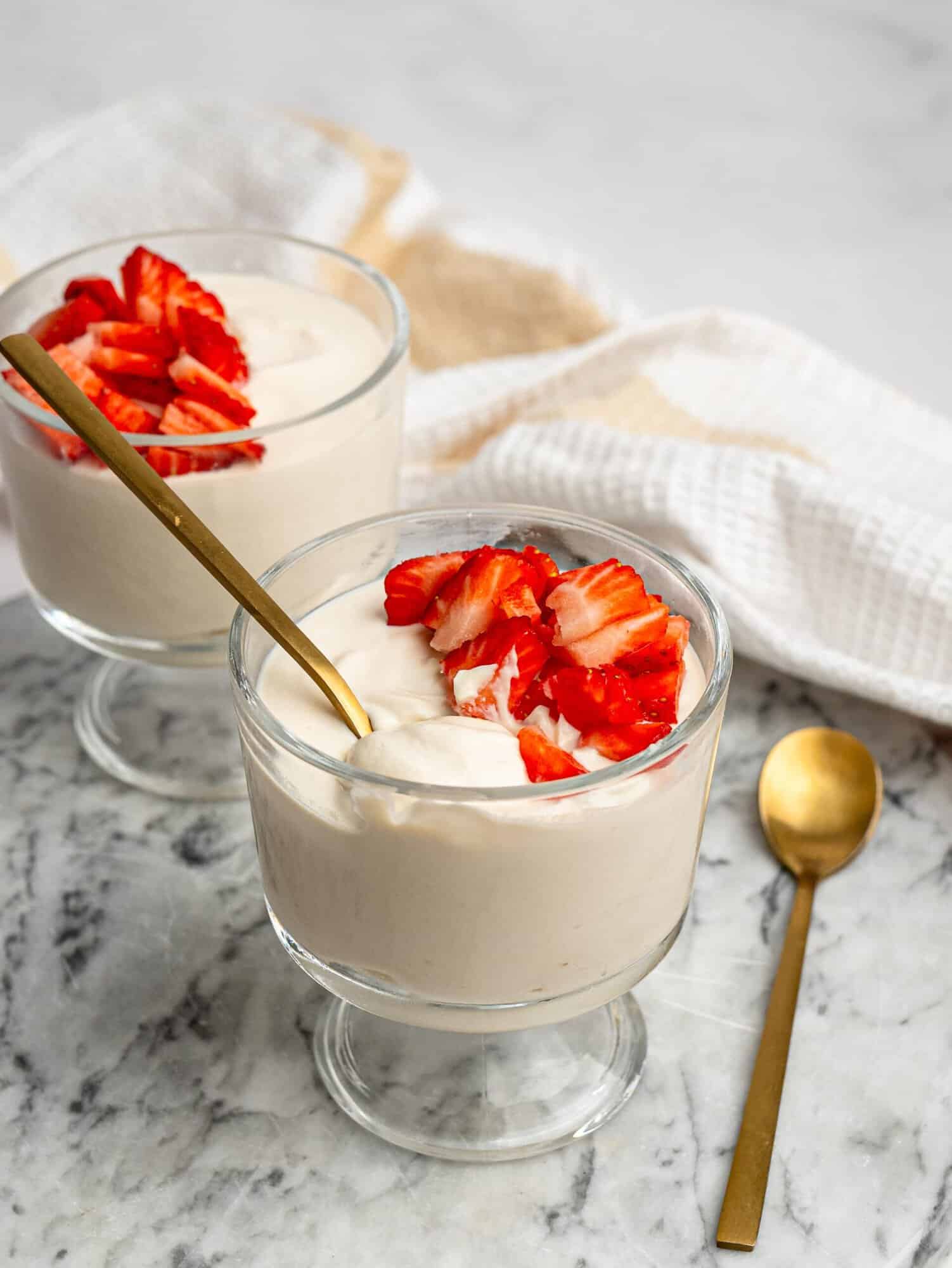 Creamy protein pudding topped with chopped fresh strawberries.