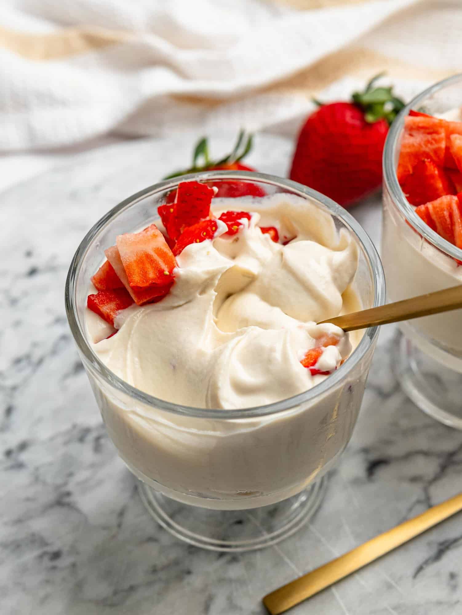 Creamy protein powder pudding topped with fresh strawberries.