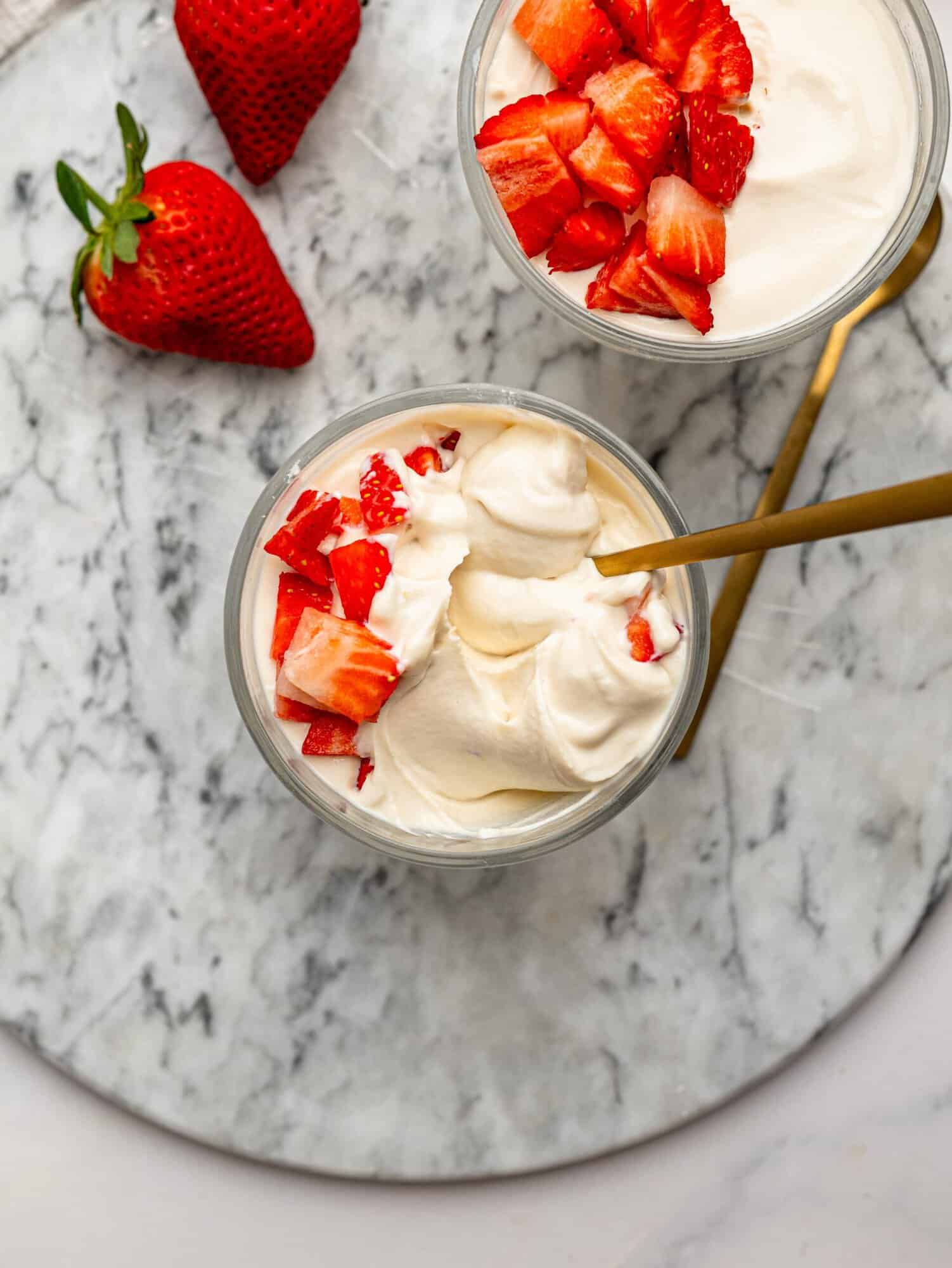 Overhead view of creamy protein powder pudding topped with strawberries.