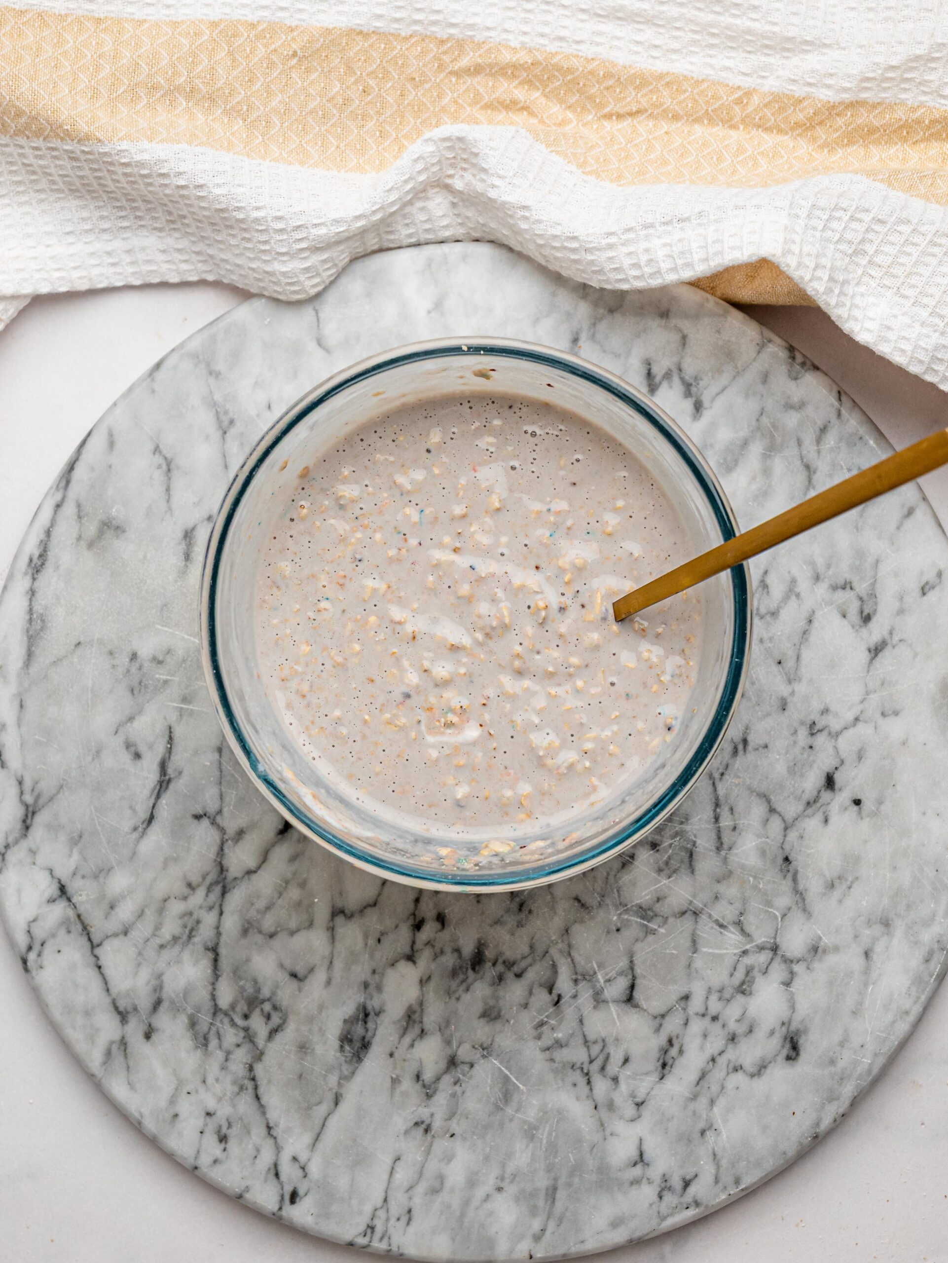 Blueberry protein overnight oats mixed Blueberry protein overnight oats mixed in a glass bowl.