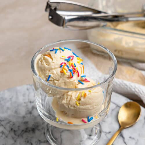 High protein ice cream served in a glass dessert bowl with colorful sprinkles.
