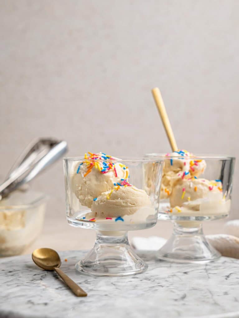 Creamy cottage cheese ice cream served in glass dessert bowls with colorful sprinkles.