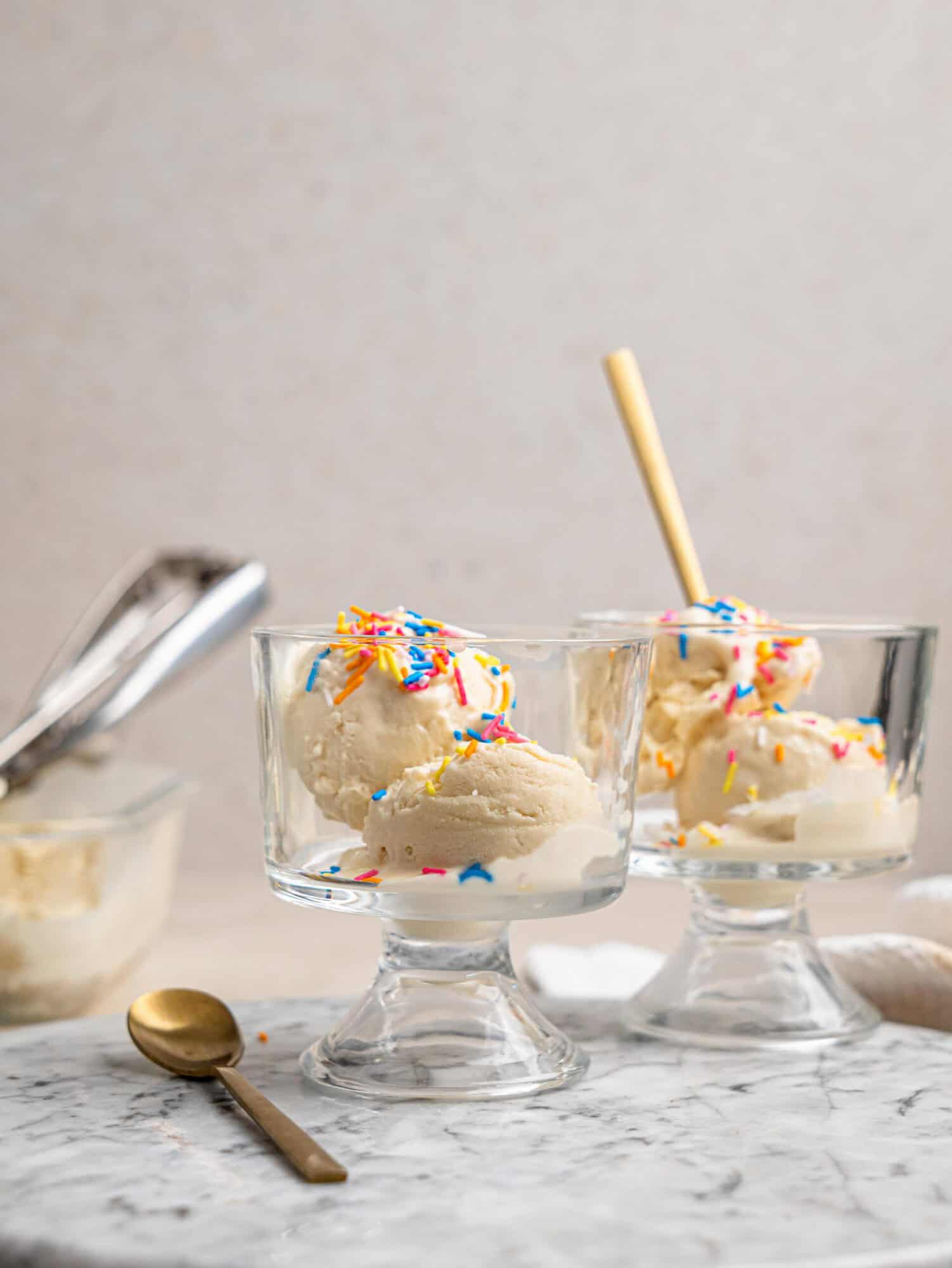 Creamy cottage cheese ice cream served in glass dessert bowls with colorful sprinkles.