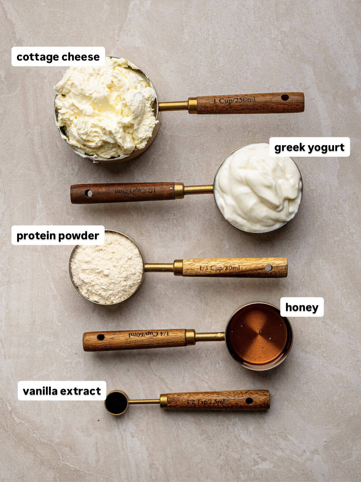 Ingredients for homemade protein ice cream including cottage cheese, Greek yoghurt, protein powder and honey.
